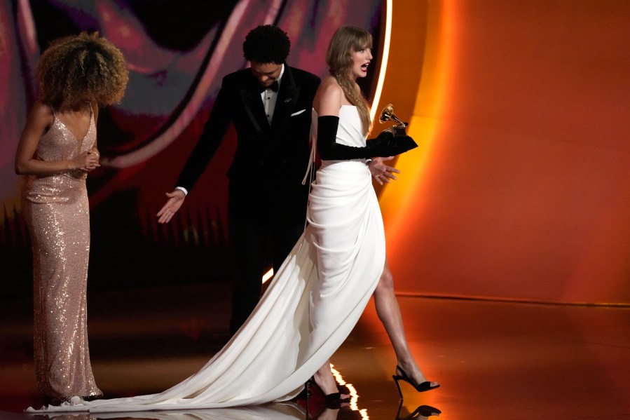 Taylor Swift accepts the award for best pop vocal album for "Midnights" during the 66th annual Grammy Awards on Sunday, Feb. 4, 2024, in Los Angeles. (AP Photo/Chris Pizzello)