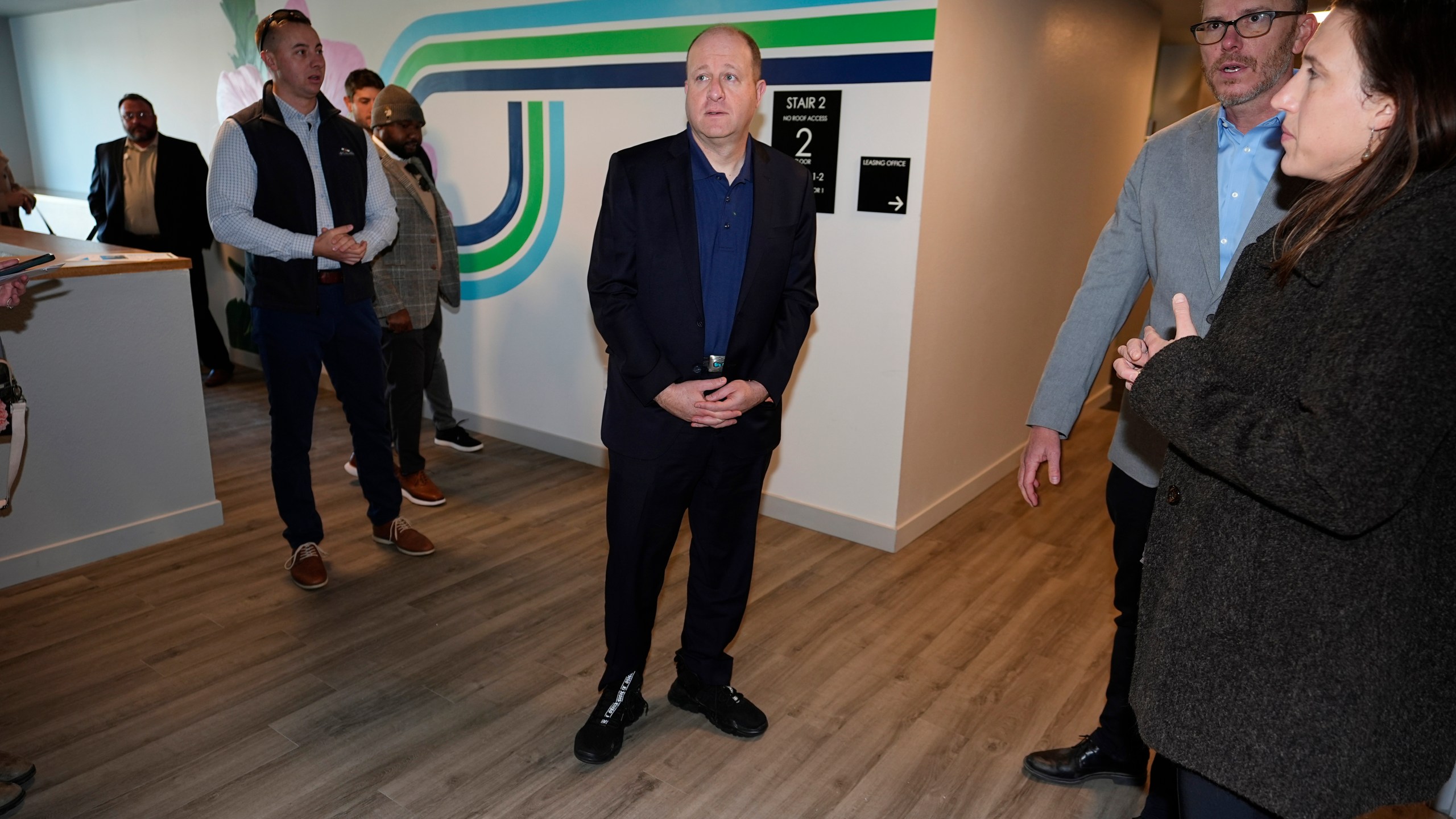 Colorado Gov. Jared Polis tours during the grand opening of the Rose on Colfax, a new affordable housing community with a co-located childcare center in the East Colfax neighborhood Wednesday, Jan. 24, 2024, in Denver. Mercy Housing, Inc., the nation's largest affordable housing nonprofit that is located in Denver, joined forces with the city of Denver and private and nonprofit organizations to build the 82-unit development in a section of the city that is undergoing rapid gentrification. (AP Photo/David Zalubowski)