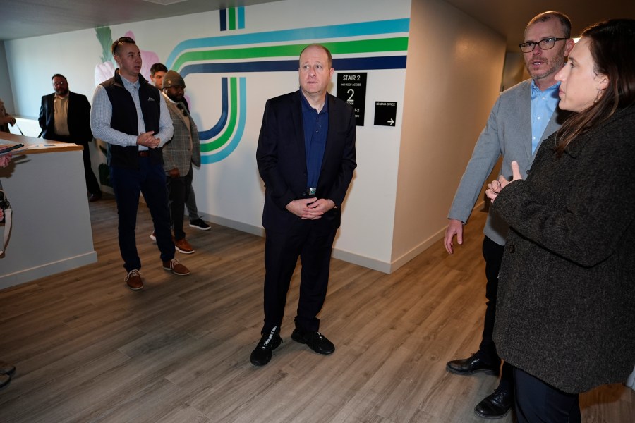 Colorado Gov. Jared Polis tours during the grand opening of the Rose on Colfax, a new affordable housing community with a co-located childcare center in the East Colfax neighborhood Wednesday, Jan. 24, 2024, in Denver. Mercy Housing, Inc., the nation's largest affordable housing nonprofit that is located in Denver, joined forces with the city of Denver and private and nonprofit organizations to build the 82-unit development in a section of the city that is undergoing rapid gentrification. (AP Photo/David Zalubowski)