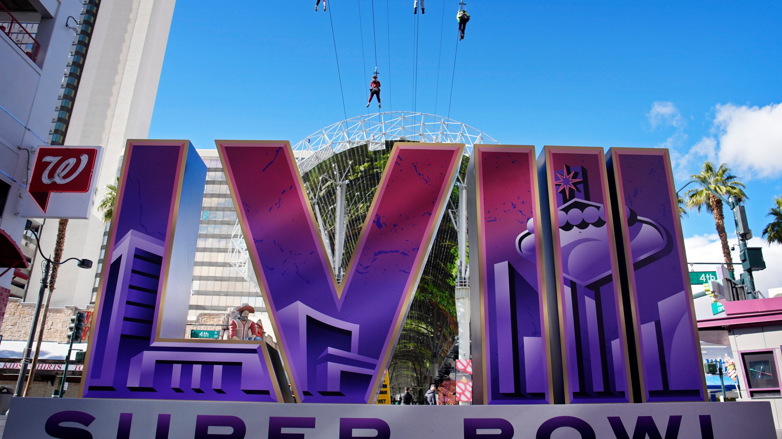 People ride a zip line above a sign for the Super Bowl ahead of the Super Bowl 58 NFL football game, Friday, Feb. 2, 2024, in Las Vegas. Las Vegas is scheduled to host the Super Bowl 58 on Sunday, Feb. 11, 2024. (AP Photo/John Locher)