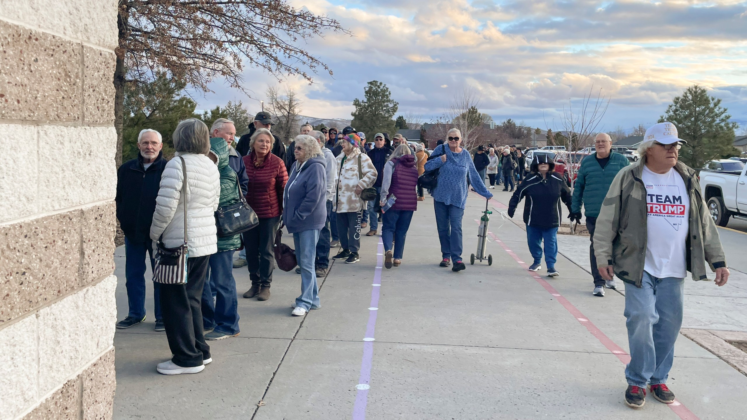 People wait in line to enter the caucus site at Spanish Springs Elementary School in Sparks, Nev., Thursday, Feb. 8, 2024. (AP Photo/Gabe Stern)