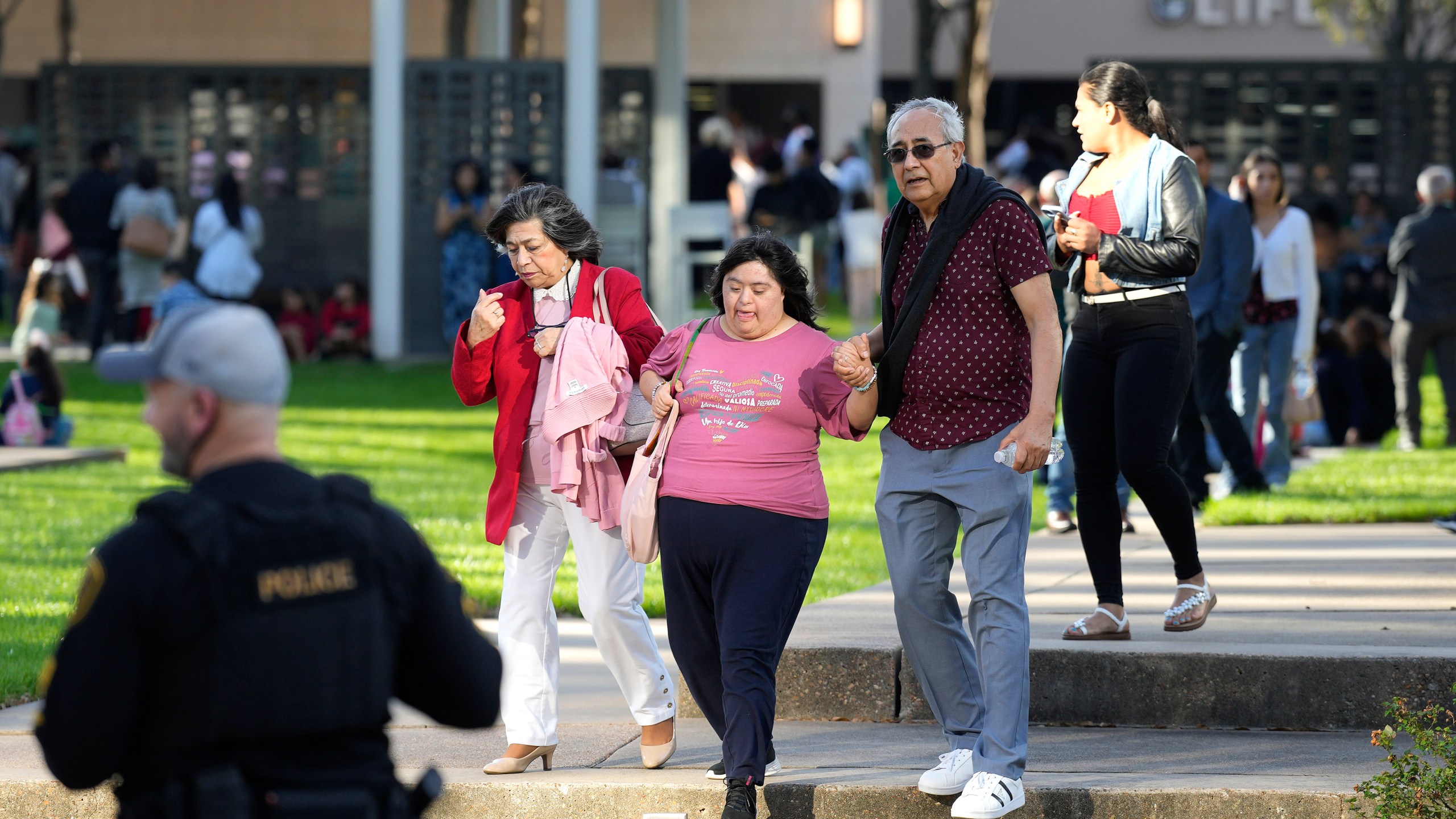 Houston Police officers watch over displaced churchgoers outside Lakewood Church, Sunday, Feb. 11, 2024, in Houston, after a reported shooting during a Spanish church service. (Karen Warren/Houston Chronicle via AP)