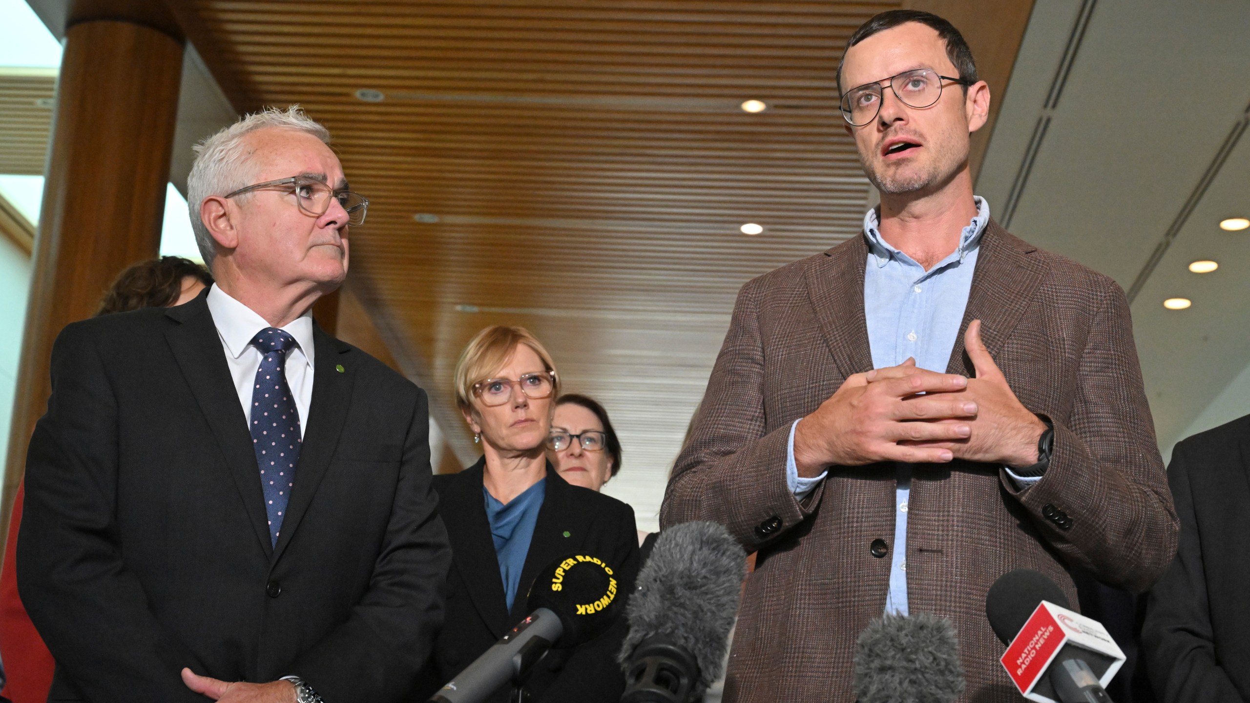 Independent member of parliament Andrew Wilkie, left, and Julian Assange's brother Gabriel Shipton, right, speak to the media at Parliament House in Canberra, Thursday, Feb. 15, 2024. Australia's House of Representatives has passed a motion calling on the United States and the UK to end the prosecution of WikiLeaks founder Julian Assange and for him to be allowed to return to his home country. (Mick Tsikas/AAP Image via AP)