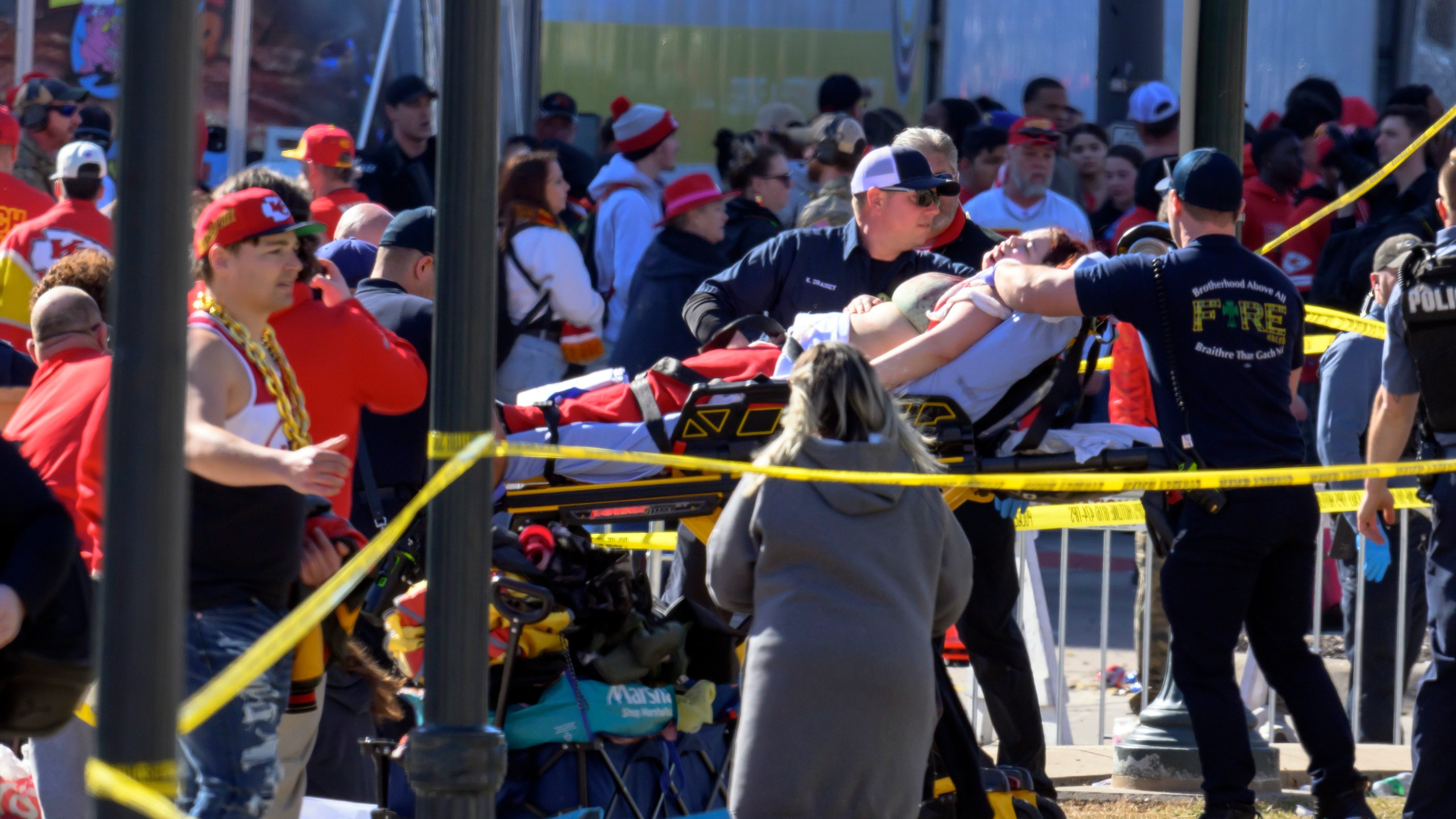 A woman is taken to an ambulance after an incident following the Kansas City Chiefs NFL football Super Bowl celebration in Kansas City, Mo., Wednesday, Feb. 14, 2024. The Chiefs defeated the San Francisco 49ers Sunday in the Super Bowl 58. (AP Photo/Reed Hoffmann)