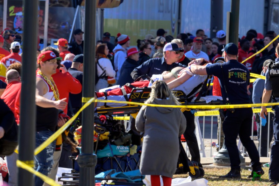 A woman is taken to an ambulance after an incident following the Kansas City Chiefs NFL football Super Bowl celebration in Kansas City, Mo., Wednesday, Feb. 14, 2024. The Chiefs defeated the San Francisco 49ers Sunday in the Super Bowl 58. (AP Photo/Reed Hoffmann)