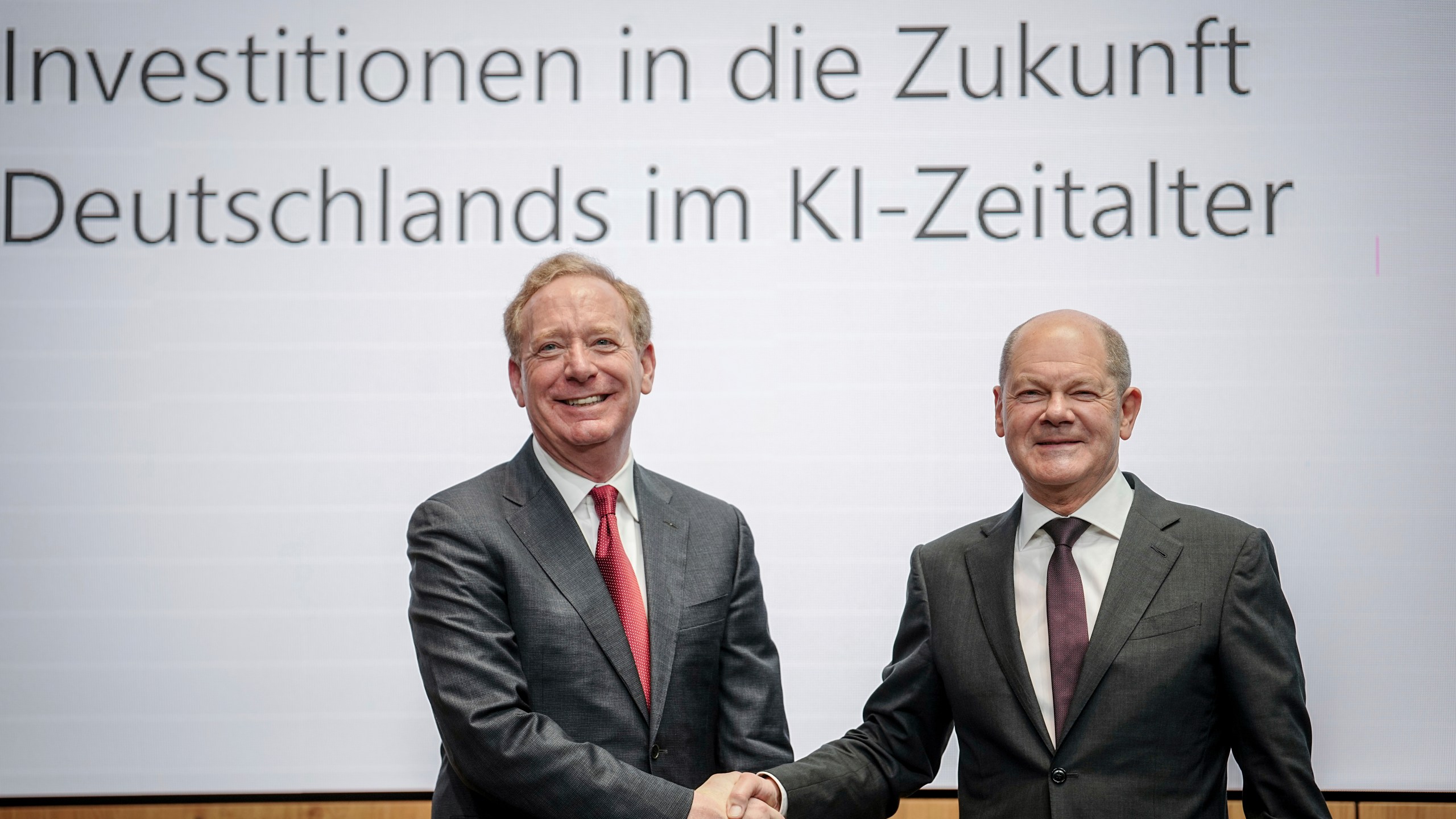 Federal Chancellor Olaf Scholz, right, and Vice Chair and President of Microsoft Corporation Brad Smith shake hands in Berlin, `Thursday, Feb. 15, 2024, after a press conference held by Microsoft Deutschland GmbH on the company's investments in the AI sector in Germany. Chancellor Olaf Scholz welcomed an announcement by Microsoft on Thursday that it would invest more than 3.2 billion euros ($3.4 billion) in Germany over the next two years to massively expand its data center capacities for applications in the field of artificial intelligence and cloud computing. (Kay Nietfeld/dpa via AP)