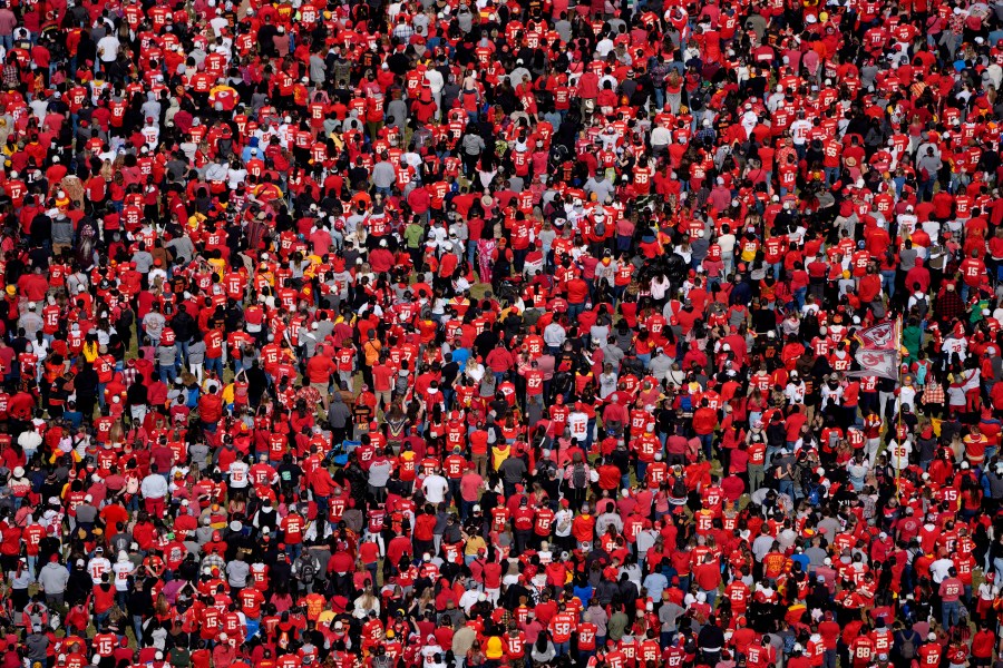 Fans watch as the Kansas City Chiefs celebrate during their victory rally at Union Station in Kansas City, Mo., Wednesday, Feb. 14, 2024. The Chiefs defeated the San Francisco 49ers Sunday in the NFL Super Bowl 58 football game. (AP Photo/Charlie Riedel)