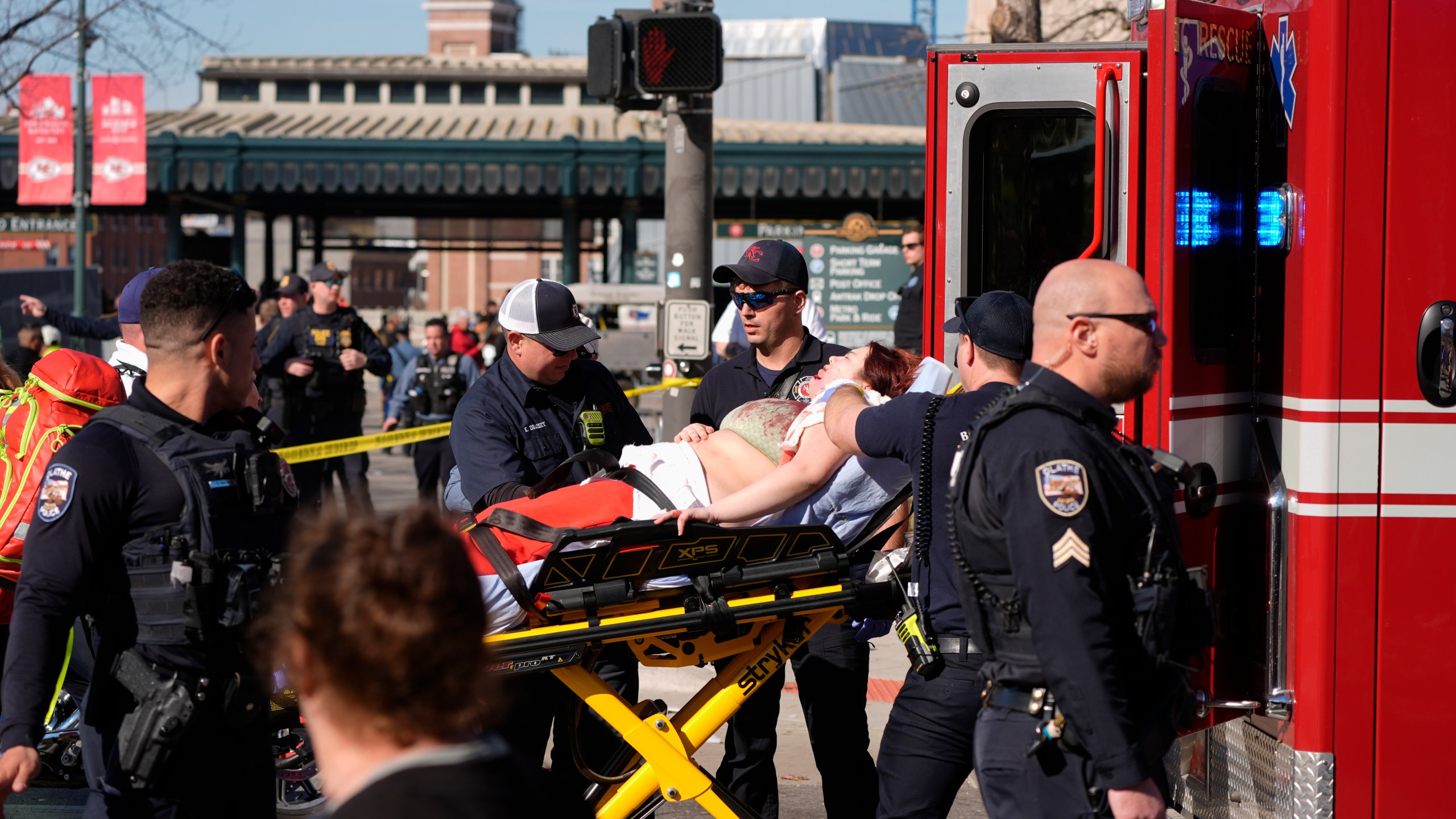 A person is taken to an ambulance after an incident following the Kansas City Chiefs victory parade in Kansas City, Mo., Wednesday, Feb. 14, 2024. The Chiefs defeated the San Francisco 49ers Sunday in the NFL Super Bowl 58 football game. (AP Photo/Charlie Riedel)