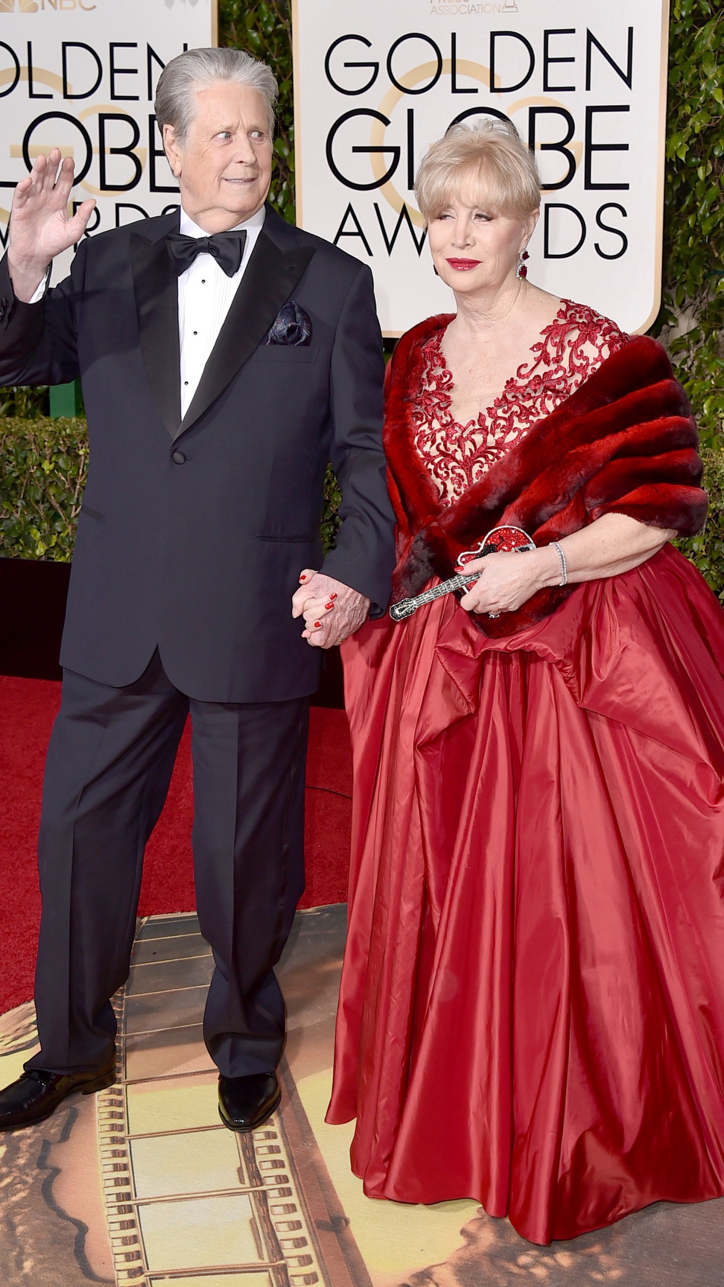 FILE - Brian Wilson, left, and his wife Melinda Ledbetter arrive at the 73rd annual Golden Globe Awards in Beverly Hills, Calif., on Jan. 10, 2016. The management team of the Beach Boys co-founder has filed papers to put him in a conservatorship. The court filing says Wilson needs someone to oversee his daily life and medical decisions because of the recent death of his wife. (Photo by Jordan Strauss/Invision/AP, File)