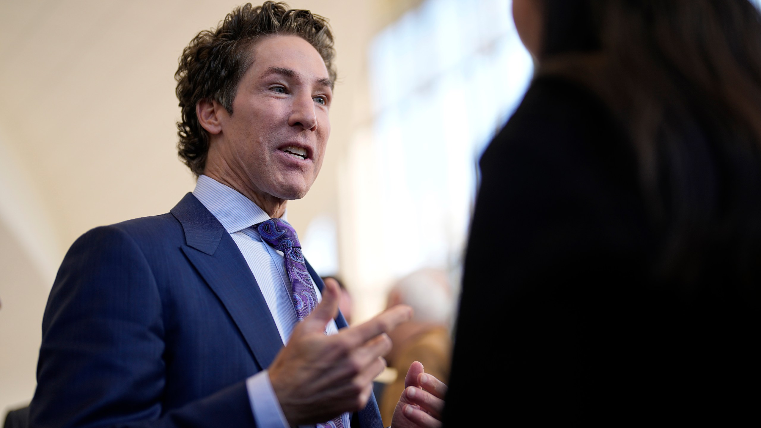 Pastor Joel Osteen talks with reporters after a service, Sunday, Feb. 18, 2024, in Houston. Pastor Osteen welcomed worshippers back to Lakewood Church for the first time since a woman with an AR-style opened fire in between services at his Texas megachurch last Sunday. (AP Photo/David J. Phillip)