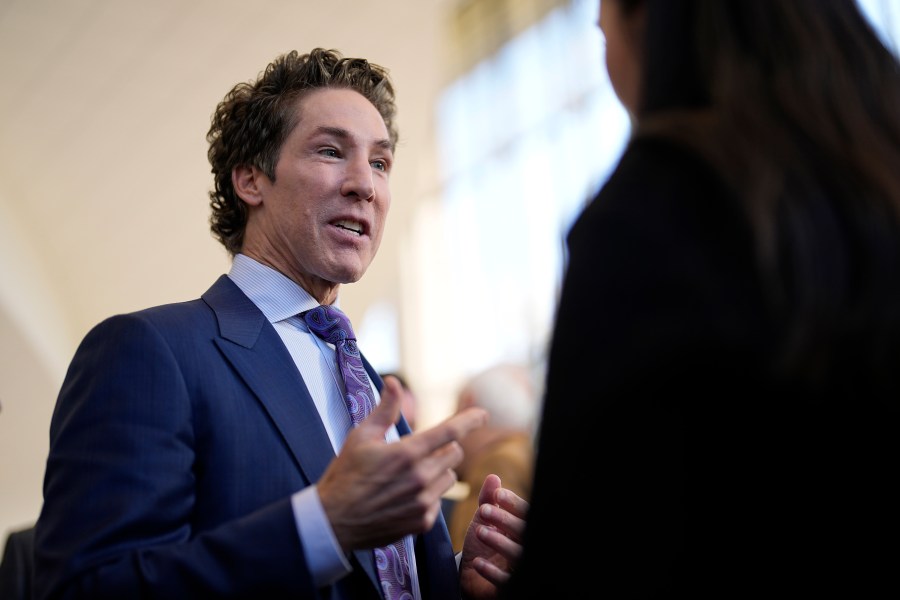 Pastor Joel Osteen talks with reporters after a service, Sunday, Feb. 18, 2024, in Houston. Pastor Osteen welcomed worshippers back to Lakewood Church for the first time since a woman with an AR-style opened fire in between services at his Texas megachurch last Sunday. (AP Photo/David J. Phillip)