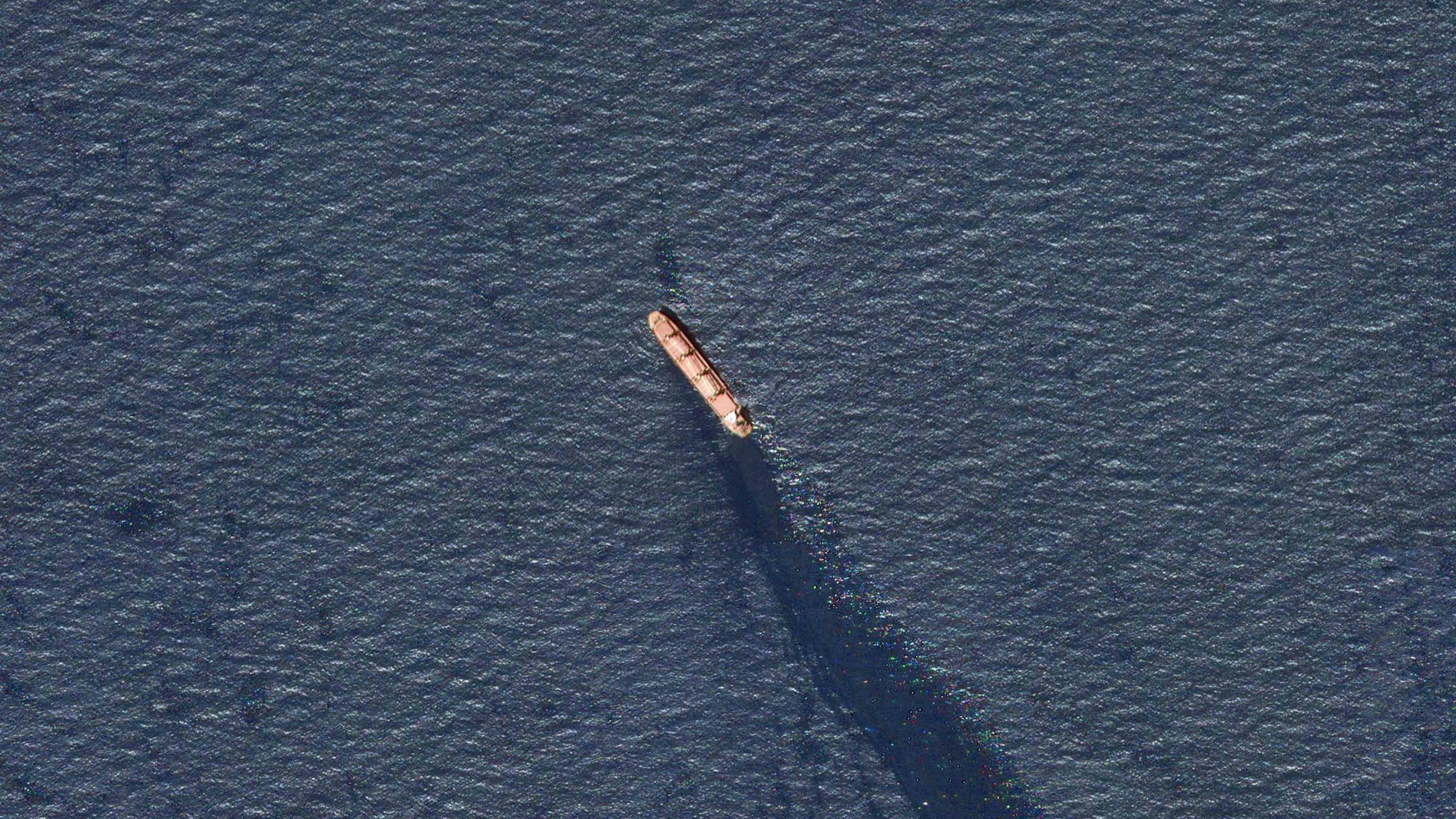 In this satellite image provided by Planet Labs, the Belize-flagged bulk carrier Rubymar is seen in the southern Red Sea near the Bay el-Mandeb Strait leaking oil after an attack by Yemen's Houthi rebels Tuesday, Feb. 20, 2024. Despite a month of U.S.-led airstrikes, Yemen's Iran-backed Houthi rebels remain capable of launching significant attacks. This week, they seriously damaged a ship in a crucial strait and apparently downed an American drone worth tens of millions of dollars. (Planet Labs PBC via AP)