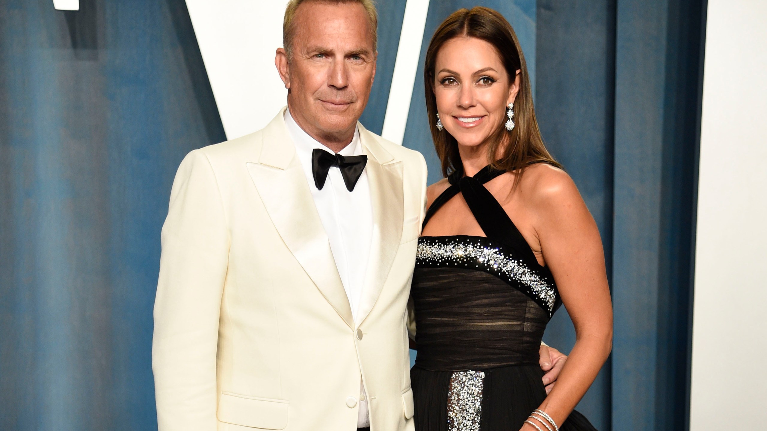 FILE - Kevin Costner, left, and Christine Baumgartner arrive at the Vanity Fair Oscar Party, March 27, 2022, in Beverly Hills, Calif. A judge has declared that Costner and his wife of nearly two decades, Baumgartner, are now legally divorced, according to court records filed Tuesday, Feb. 20, 2024. (Photo by Evan Agostini/Invision/AP, File)