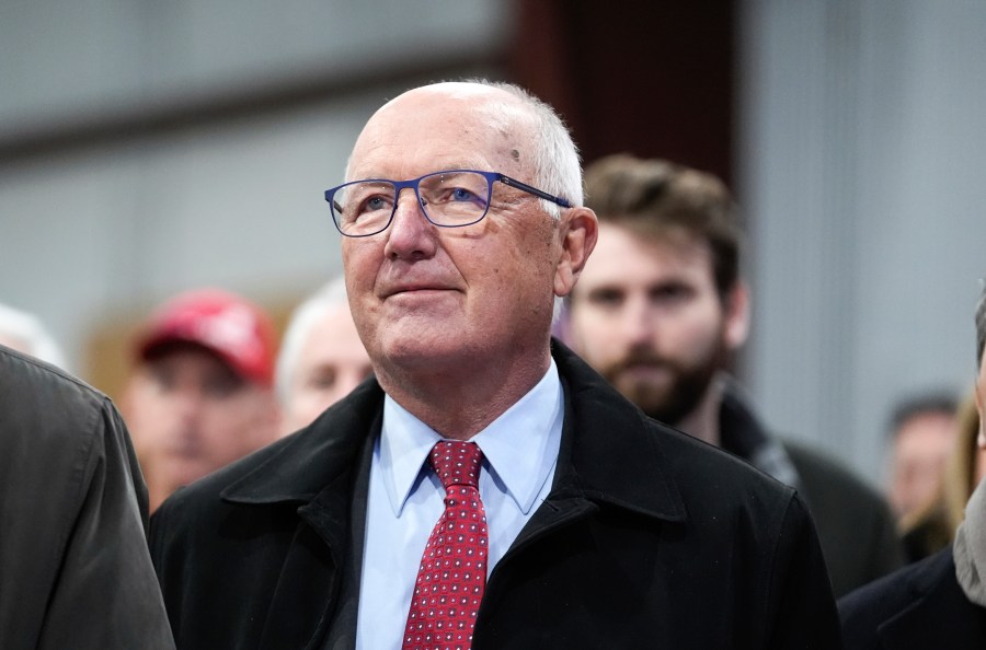 FILE - Michigan Republican Party chair Pete Hoekstra listens to Republican presidential candidate former President Donald Trump at a campaign rally in Waterford Township, Mich., Saturday, Feb. 17, 2024. Michigan Republicans are planning dueling presidential nominating conventions that will take place March 2, even though the national Republican Party said members properly removed former chair Kristina Karamo and recognized former Congressman Hoekstra as the party's new chair. Hoekstra announced Tuesday, Feb. 20, that he would hold a presidential nominating convention in Grand Rapids on the same day Karamo and her backers plan to hold one in Detroit. (AP Photo/Paul Sancya, File)