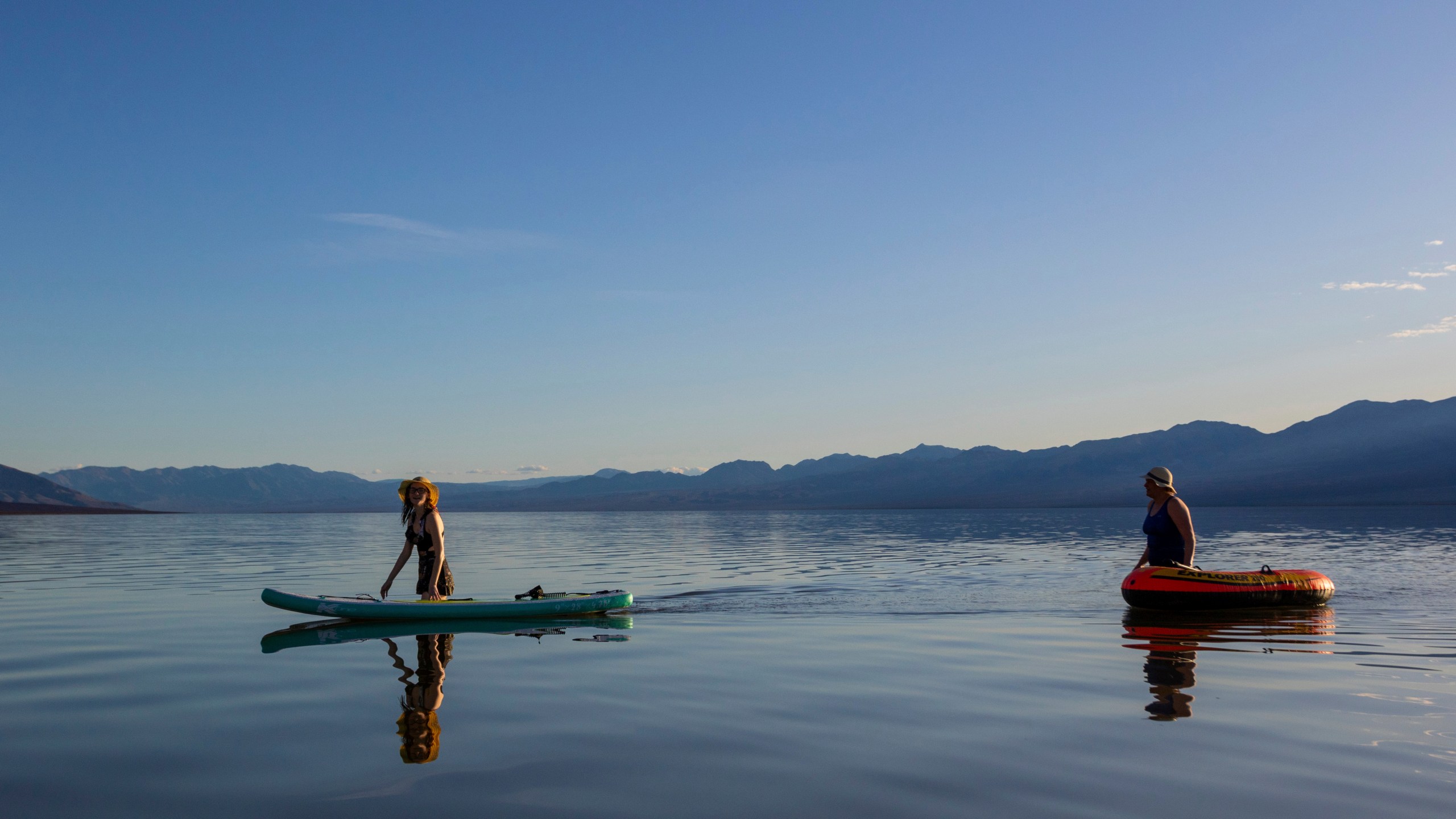 Alexandria Klein, left, and Laura Klein ride on a temporary lake in Death Valley on Thursday, Feb. 23, 2024, in Death Valley National Park, Calif. A series of storms have brought more than double the parks annual rainfall in the past six months. (AP Photo/Ty ONeil)