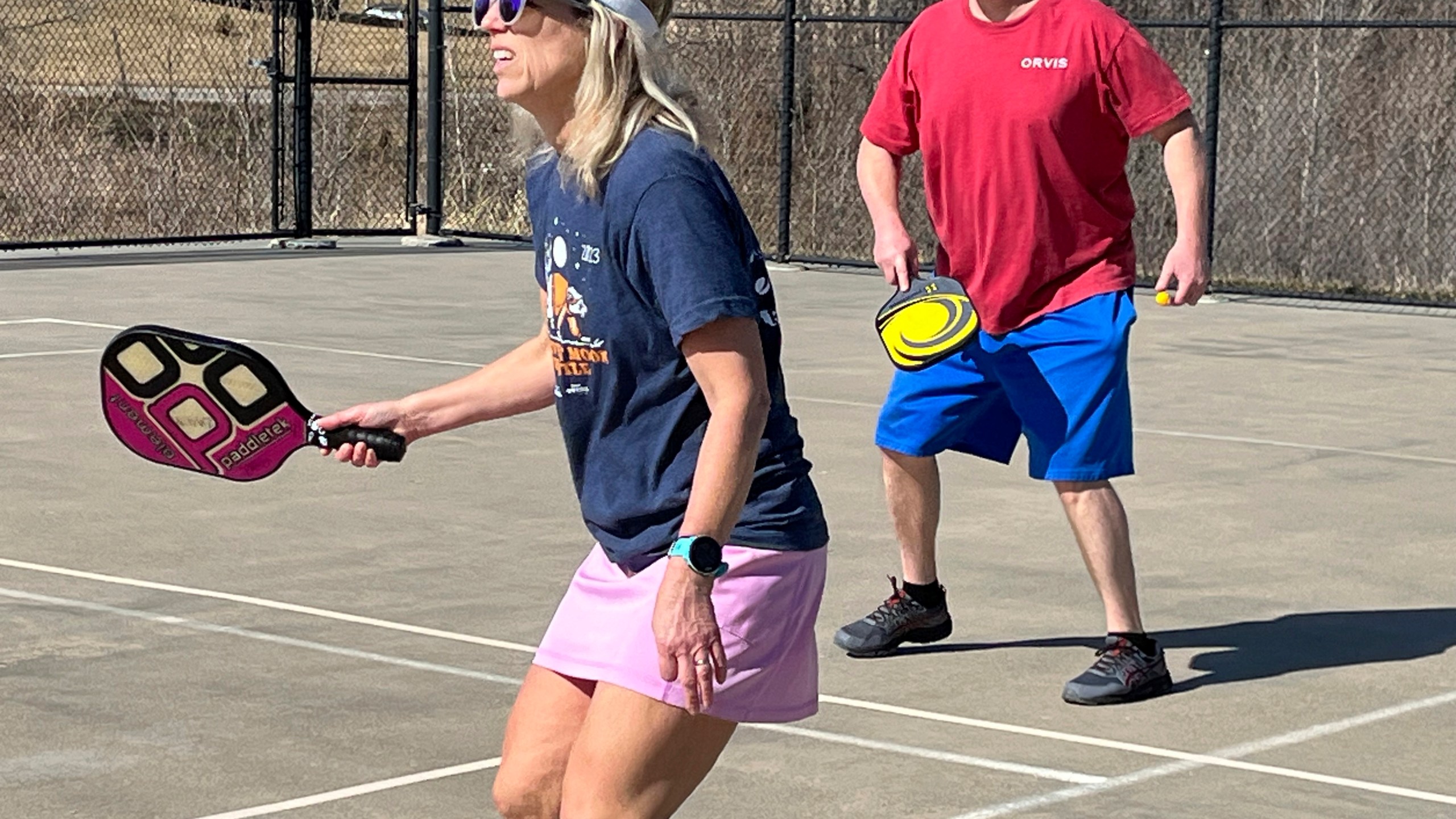 Stacy Lawson, left, and her husband, Hugh Lawson, play a game of pickleball on an outdoor court in Omaha, Neb., Sunday, Feb. 25, 2024. Temperatures usually hover around freezing this time of year. (AP Photo/Margery Beck)