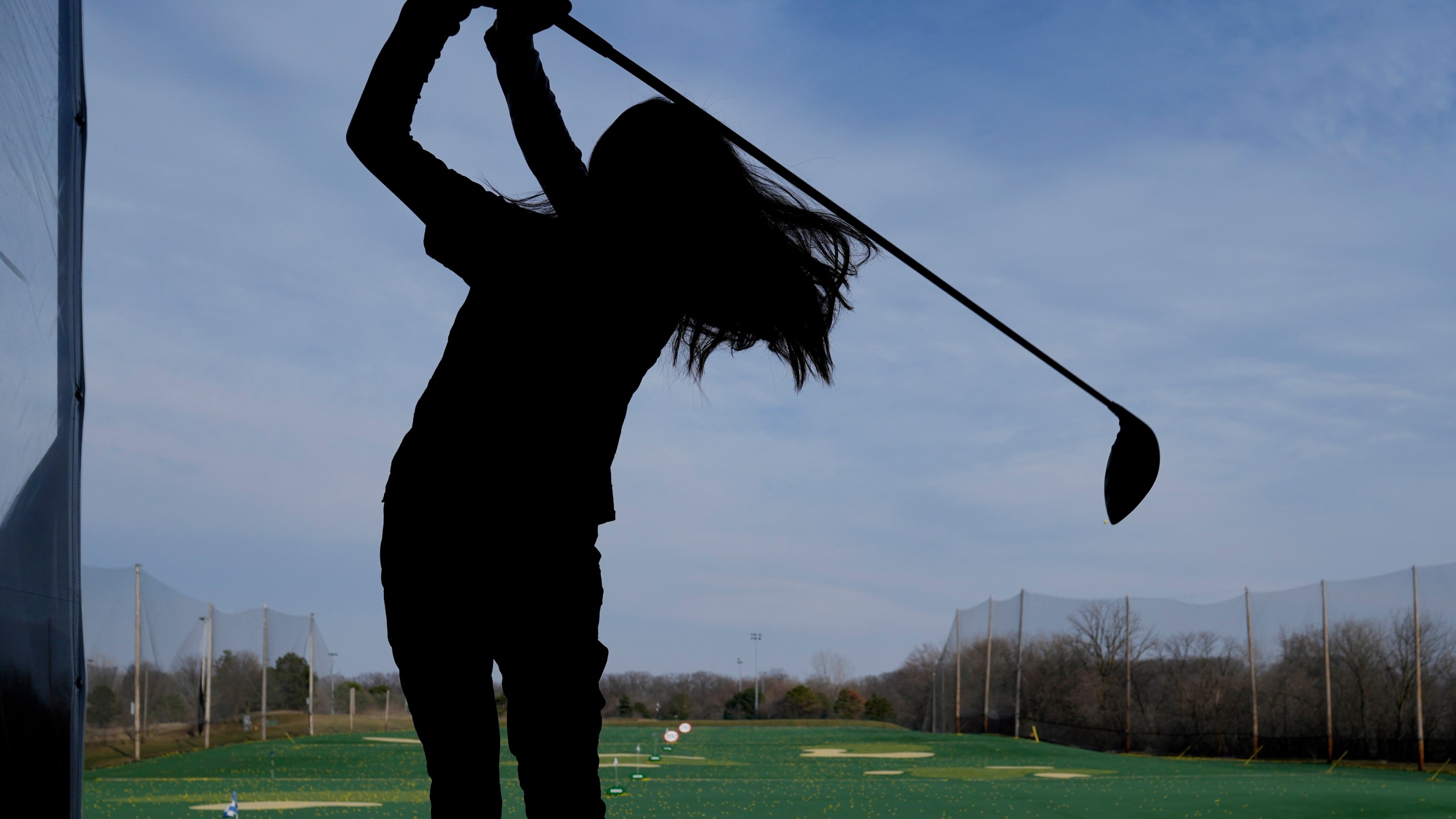 A golfer hits range balls during a warm day in Des Plaines, Ill., Tuesday, Feb. 27, 2024. Illinois broke a 24 year old temp record with today's estimated 68 degree high and a 98 year old record set back in 1926 appears potentially in jeopardy Tuesday. These readings are May level temps, the equivalent of normal temps which occur here more than 2 months from now. (AP Photo/Nam Y. Huh)