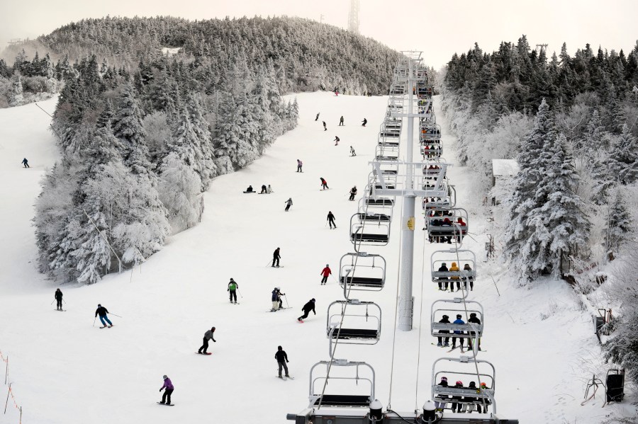 FILE - Thanksgiving holiday skiers descend near the North Ridge Quad chairlift, Nov. 24, 2023, at Killington Ski Resort in Killington, Vt. A new study says U.S. ski areas lost about $5 billion from 2000 to 2019 as a result of human-caused climate change. (AP Photo/Robert F. Bukaty, File)