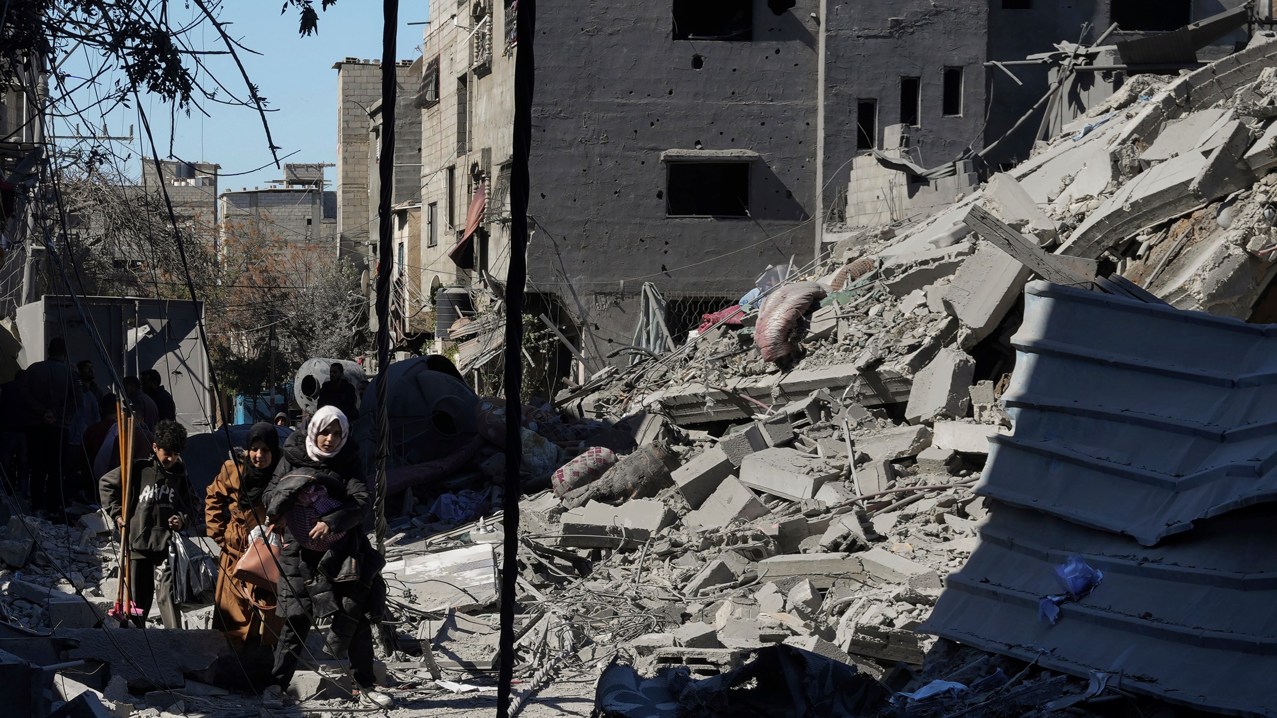 Palestinians inspect the rubble of destroyed buildings after an Israeli airstrike in Nusseirat refugee camp, central Gaza Strip, on Thursday, Feb. 29, 2024. (AP Photo/Adel Hana)