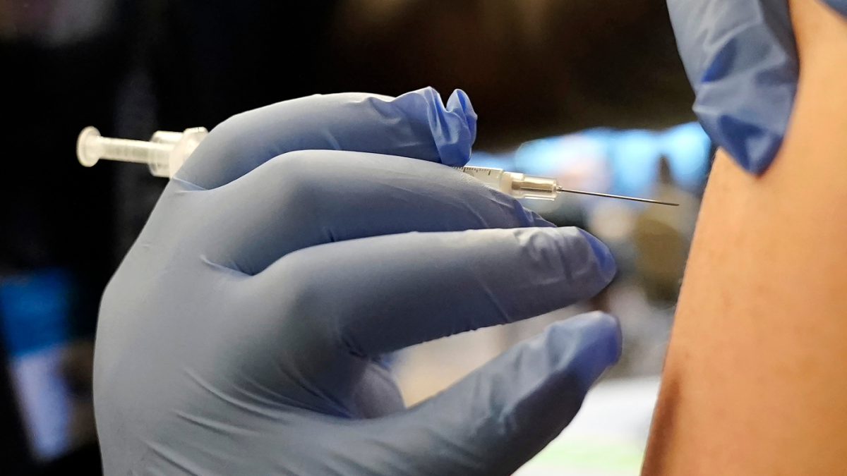 A person receives a Pfizer COVID-19 vaccine booster shot in Federal Way, Wash.