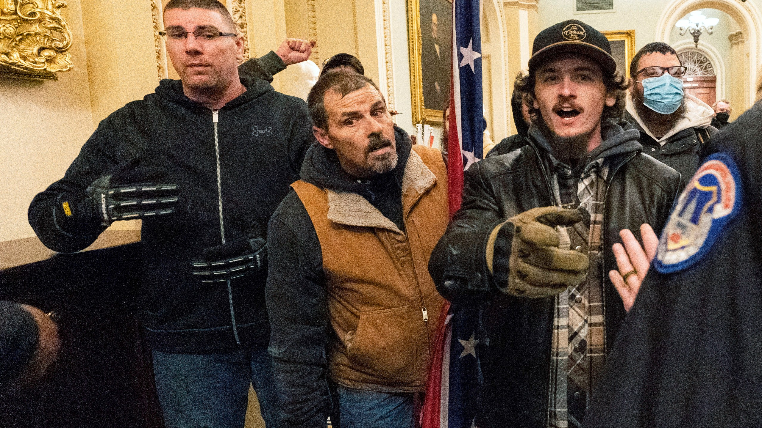 FILE - Michael Sparks, left, and Kevin Seefried, second from left, as they and other insurrectionists loyal to President Donald Trump are confronted by U.S. Capitol Police officers outside the Senate Chamber inside the Capitol in Washington, Jan. 6, 2021. Sparks, the first rioter to enter the Capitol building during the Jan. 6, 2021, attack has been convicted of charges that he interfered with police and obstructed Congress from certifying President Joe Biden's 2020 electoral victory.(AP Photo/Manuel Balce Ceneta, File)