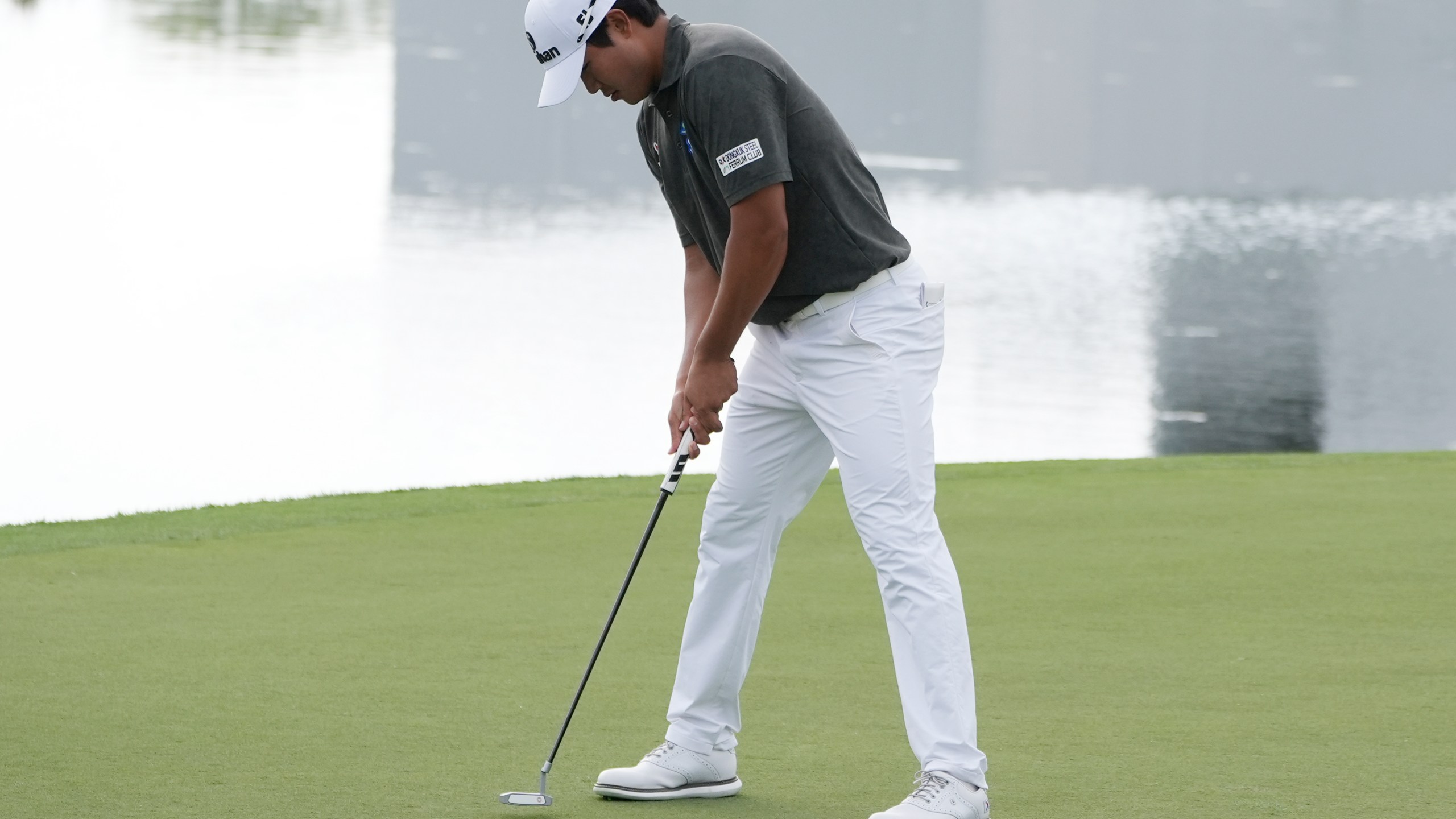 S.H. Kim of South Korea drops his putt on the 17th hole during the first round of the Cognizant Classic golf tournament, Thursday, Feb. 29, 2024, in Palm Beach Gardens, Fla. (AP Photo/Marta Lavandier)