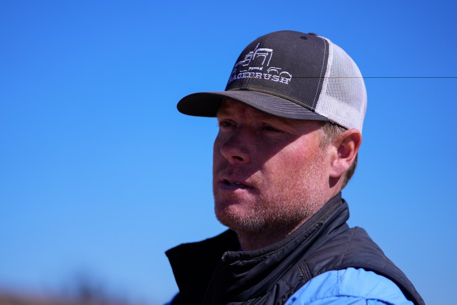 Chance Bowers looks on as his dead cattle is collected after he lost more than 200 head of cattle in the Smokehouse Creek Fire, Friday, March 1, 2024, in Skellytown, Texas. The wildfire, which started Monday, has left behind a charred landscape of scorched prairie, dead cattle and burned-out homes in the Texas Panhandle. (AP Photo/Julio Cortez)