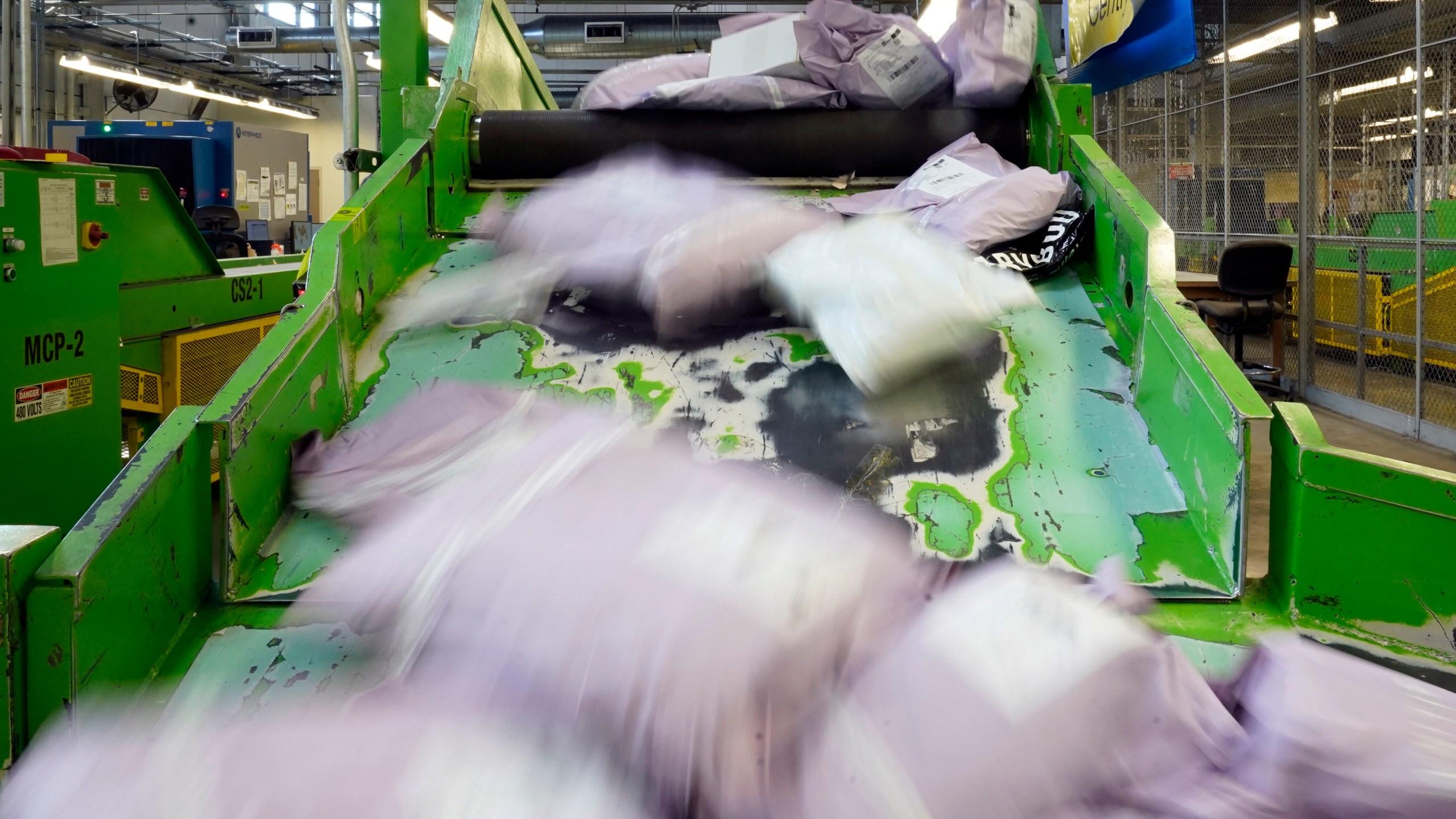 Parcels slide down a ramp after being scanned at the U.S. Customs and Border Protection overseas mail inspection facility at Chicago's O'Hare International Airport Feb. 23, 2024, in Chicago. The explosive growth of cross-border e-commerce involving major China-backed players such as Shein and Temu has caught the attention of the U.S. lawmakers amid a bitter U.S.-China trade war and cast a spotlight on a tax rule that critics say has allowed hundreds of millions of China-originated packages to enter the U.S. market each year without duty and without reliable information for lawfulness. (AP Photo/Charles Rex Arbogast)