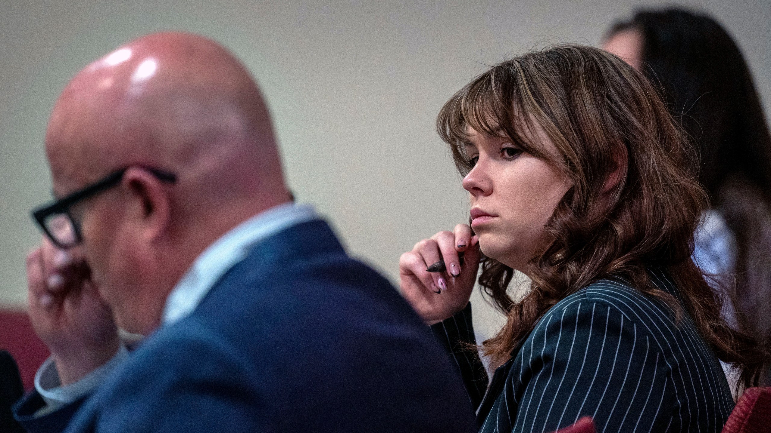 Hannah Gutierrez-Reed, center, sits with her attorney Jason Bowles, left, during testimony in the trial against her in First District Court, in Santa Fe, N.M., Friday, March, 1, 2024. Gutierrez-Reed was working as the armorer on the movie "Rust" when actor Alec Baldwin fatally shot cinematographer Halyna Hutchins and wounded Souza. Gutierrez-Reed is fighting involuntary manslaughter and tampering with evidence charges.(Eddie Moore/The Albuquerque Journal via AP, Pool)