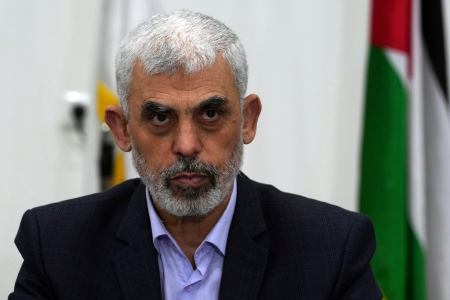 FILE - Yehya Sinwar, head of Hamas in Gaza, chairs a meeting with leaders of Palestinian factions at his office in Gaza City, Wednesday, April 13, 2022. Israel can either try to annihilate Hamas, which would mean almost certain death for the estimated 100 hostages still held in Gaza, or it can cut a deal that would allow the militants to claim a historic victory. Either outcome would be excruciating for Israelis. And either might be seen as acceptable by Hamas, which valorizes martyrdom. (AP Photo/Adel Hana, File)