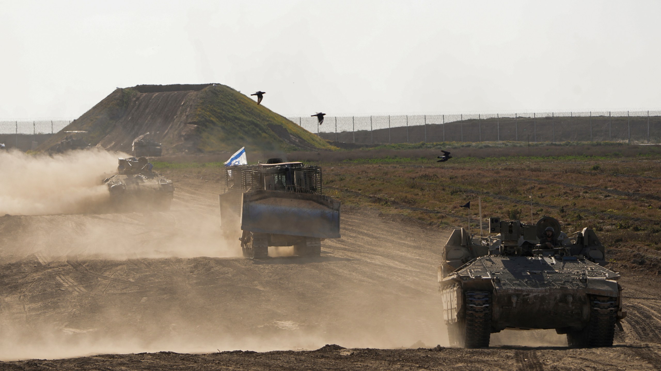 FILE - Israeli troops move near the Gaza Strip border in southern Israel, Monday, March 4, 2024. The army is battling Palestinian militants across Gaza in the war ignited by Hamas' Oct. 7 attack into Israel. Israel can either try to annihilate Hamas, which would mean almost certain death for the estimated 100 hostages still held in Gaza, or it can cut a deal that would allow the militants to claim a historic victory. Either outcome would be excruciating for Israelis. And either might be seen as acceptable by Hamas, which valorizes martyrdom. (AP Photo/Ohad Zwigenberg, File)