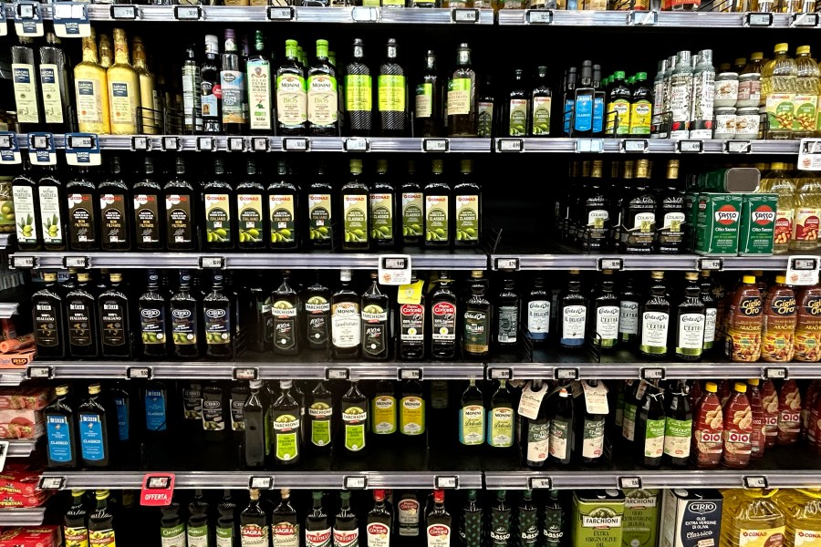 Olive oil bottles are seen in a supermarket in Rome, Friday, March 8, 2024. One-third of Italians have reduced their consumption of extra virgin olive oil due to skyrocketing prices, according to a survey released Friday. But Italian producers are pushing back against the data, saying the snapshot of consumer sentiment does not give a full picture — and that sales of higher-quality Italian extra virgin olive oil are actually up. (AP Photo/Alessandra Tarantino)