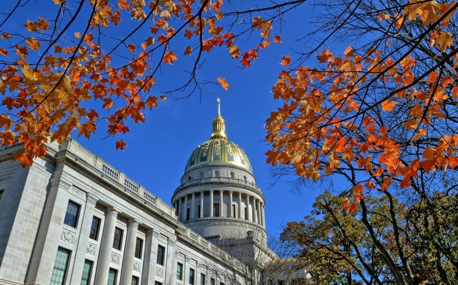 FILE - The West Virginia Capitol with its dome framed by turning sugar maples leaves is seen, Nov. 3, 2014, in Charleston, W.Va. Lawmakers in West Virginia's GOP-controlled state Legislature voted Saturday, March 9, 2024, to allow some students who don't attend traditional public schools to be exempt from state vaccination requirements that have long been held up as some of the most strict in the country. (Tom Hindman/The Daily Mail via AP, File)