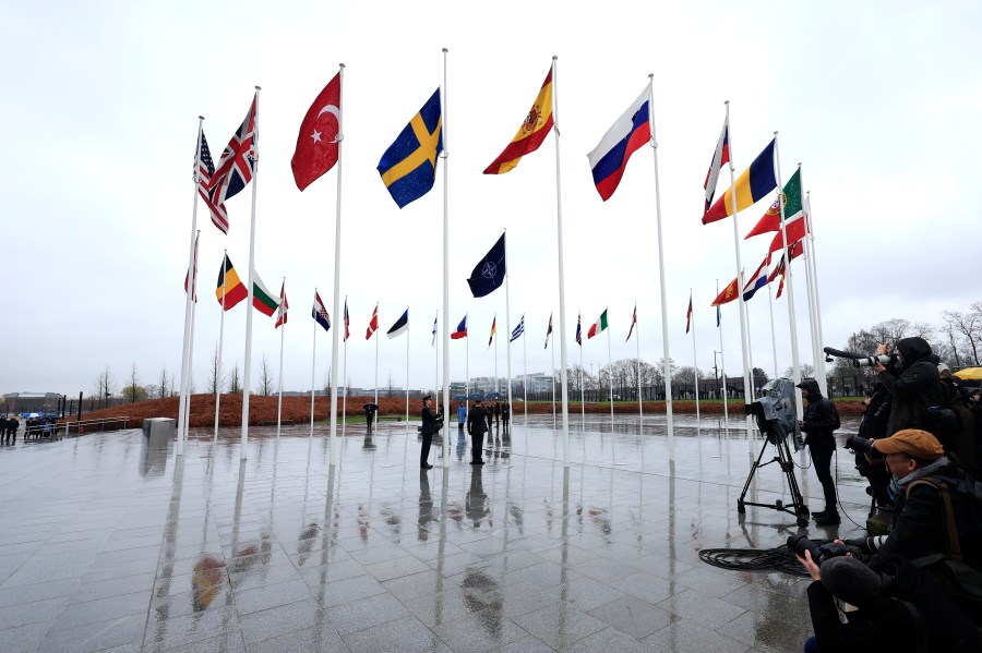 Members of the military raise the flag of Sweden on its newly installed pole during a ceremony to mark the accession of Sweden to NATO at NATO headquarters in Brussels, Monday, March 11, 2024. (AP Photo/Geert Vanden Wijngaert)