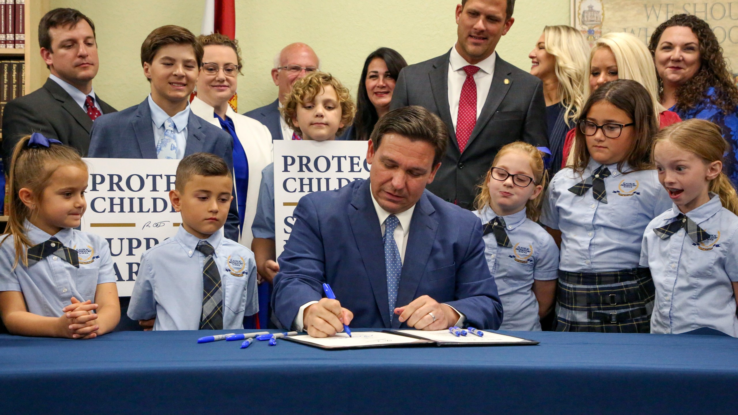 FILE - Florida Gov. Ron DeSantis signs the Parental Rights in Education bill, also known as the "Don't Say Gay" bill, at Classical Preparatory School, March 28, 2022, in Shady Hills, Fla. Students and teachers will be able to speak freely about sexual orientation and gender identity in Florida classrooms, provided it’s not part of instruction, under a settlement reached Monday, March 11, 2024, between Florida education officials and civil rights attorneys who had challenged a state law which critics dubbed “Don't Say Gay.” (Douglas R. Clifford/Tampa Bay Times via AP, File)