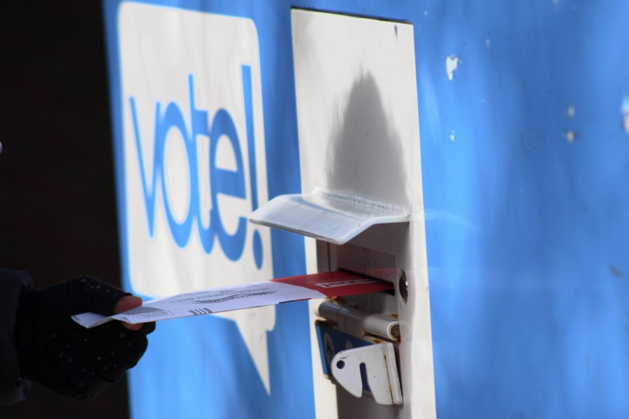 A person drops off a ballot at a drop box during the presidential primary election, Tuesday, March 12, 2024, in Seattle. (AP Photo/Manuel Valdes)