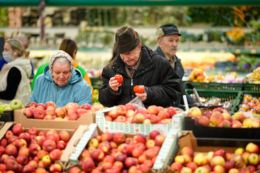 FILE - People buy fruit at a market in Moscow, Russia, on Nov. 3, 2023. The shelves at Moscow supermarkets are full of fruit, vegetables, cheese and meat, but many shoppers look at the selection with dismay as inflation drives up their price. (AP Photo)