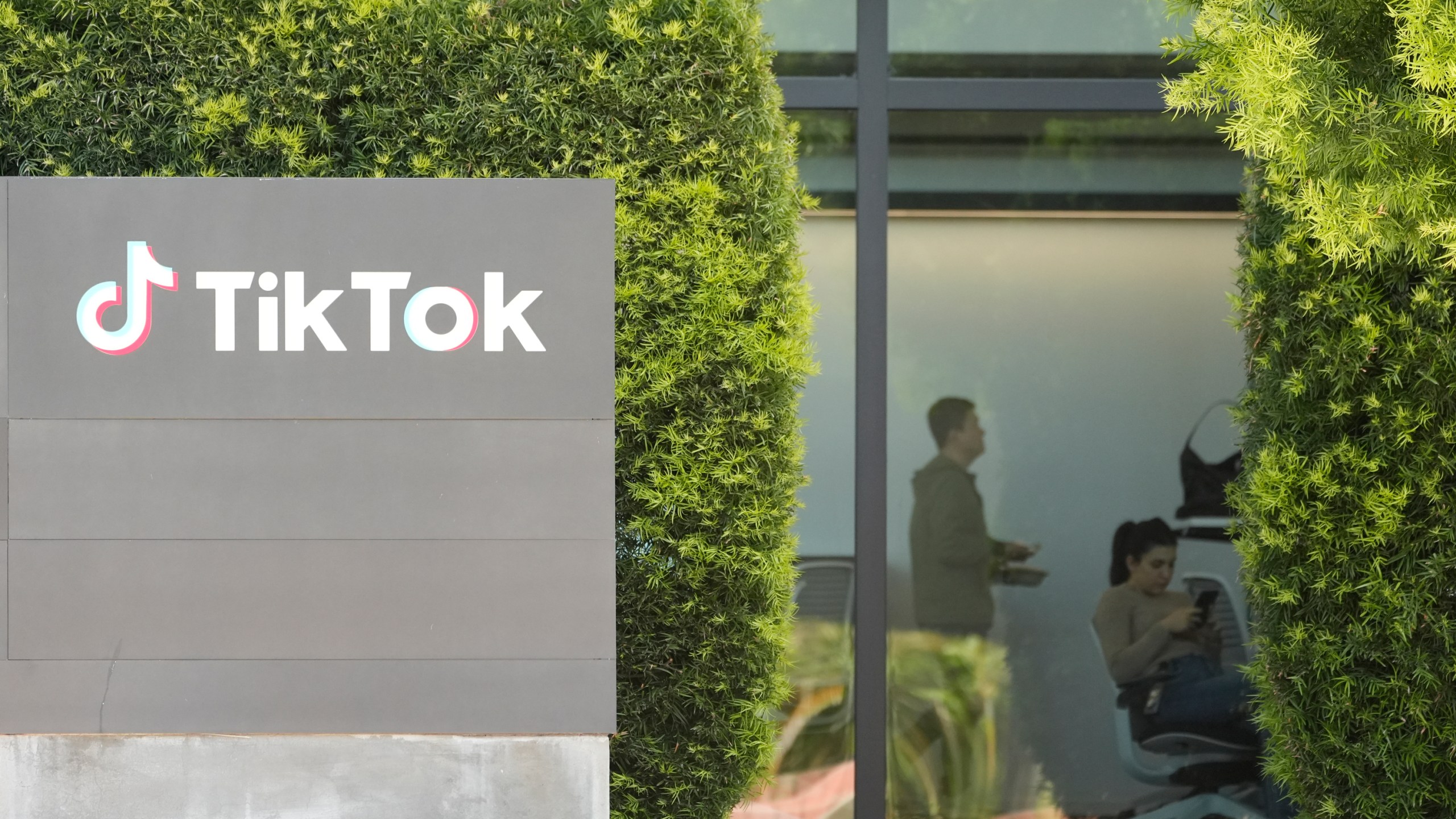 People work inside the TikTok Inc. building in Culver City, Calif., Monday, March 11, 2024. House Republicans are moving ahead with a bill that would require Chinese company ByteDance to sell TikTok or face a ban in the United States even as President Donald Trump is voicing opposition to the effort. (AP Photo/Damian Dovarganes)