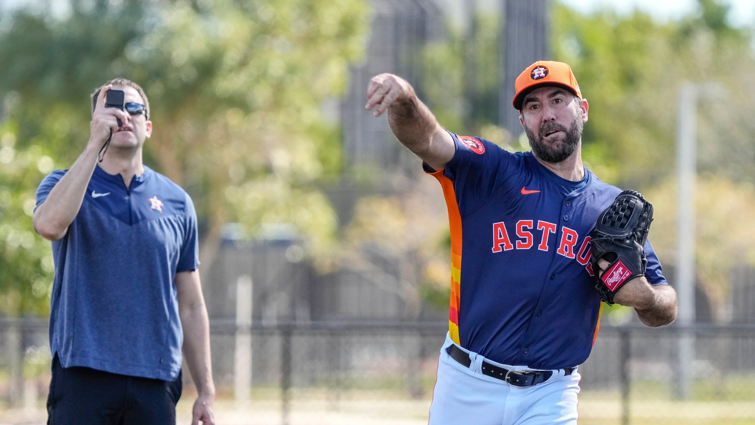 FILE - Houston Astros pitcher Justin Verlander (35) warms up as head athletic trainer Jeremiah Randall observes during spring training baseball workouts, Thursday, Feb. 15, 2024, in West Palm Beach, Fla. There is a bridge that runs from Tommy John and Dr. Frank Jobe in 1974, all the way to Shohei Ohtani, Justin Verlander and Bryce Harper. (Karen Warren/Houston Chronicle via AP, File)