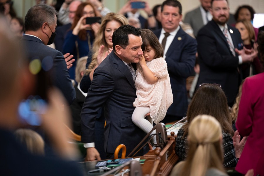 FILE - Assemblyman Anthony Rendon walks with his daughter Vienna before being sworn in as Speaker of the Assembly during the opening session of the California Legislature in Sacramento, Calif., Monday, Dec. 5, 2022. Rendon created the Select Committee on Happiness and Public Policy Outcomes to study how state policy can make Californians happier. (AP Photo/José Luis Villegas, Pool,File)