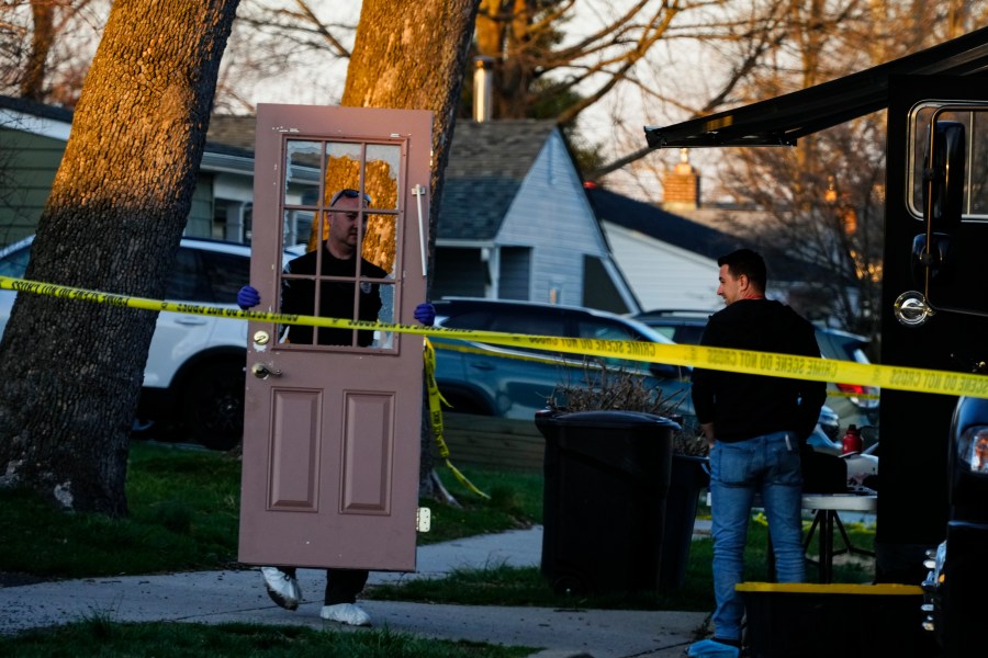 An investigator collects evidence from the scene of a fatal shooting in Levittown, Pa., Saturday, March 16, 2024. Police say a man suspected of killing multiple family members in the Philadelphia area has been arrested in New Jersey. (AP Photo/Matt Rourke)