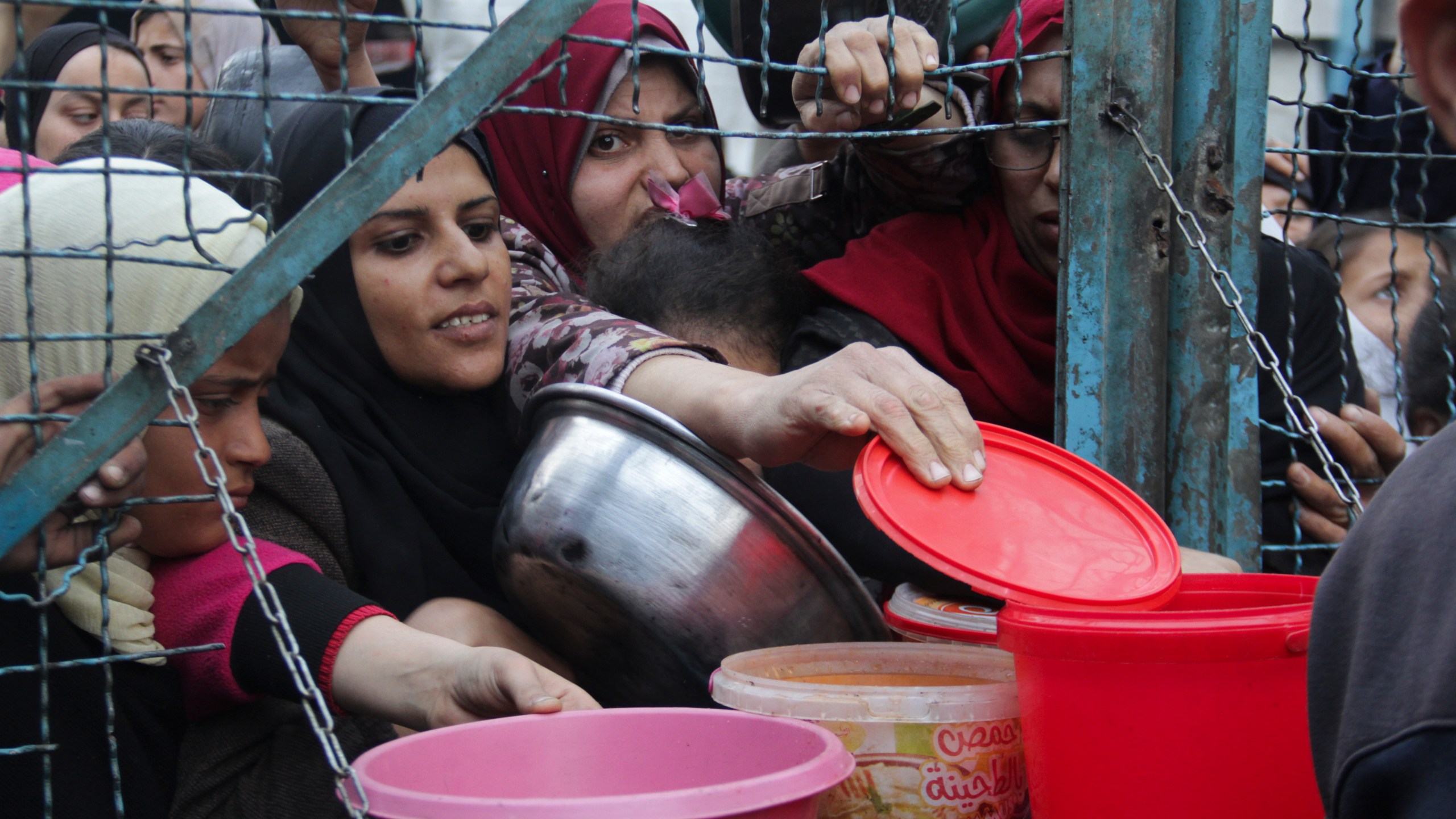 Palestinians line up to receive free meals at Jabaliya refugee camp in the Gaza Strip on Monday, March 18, 2024. (AP Photo/Mahmoud Essa)