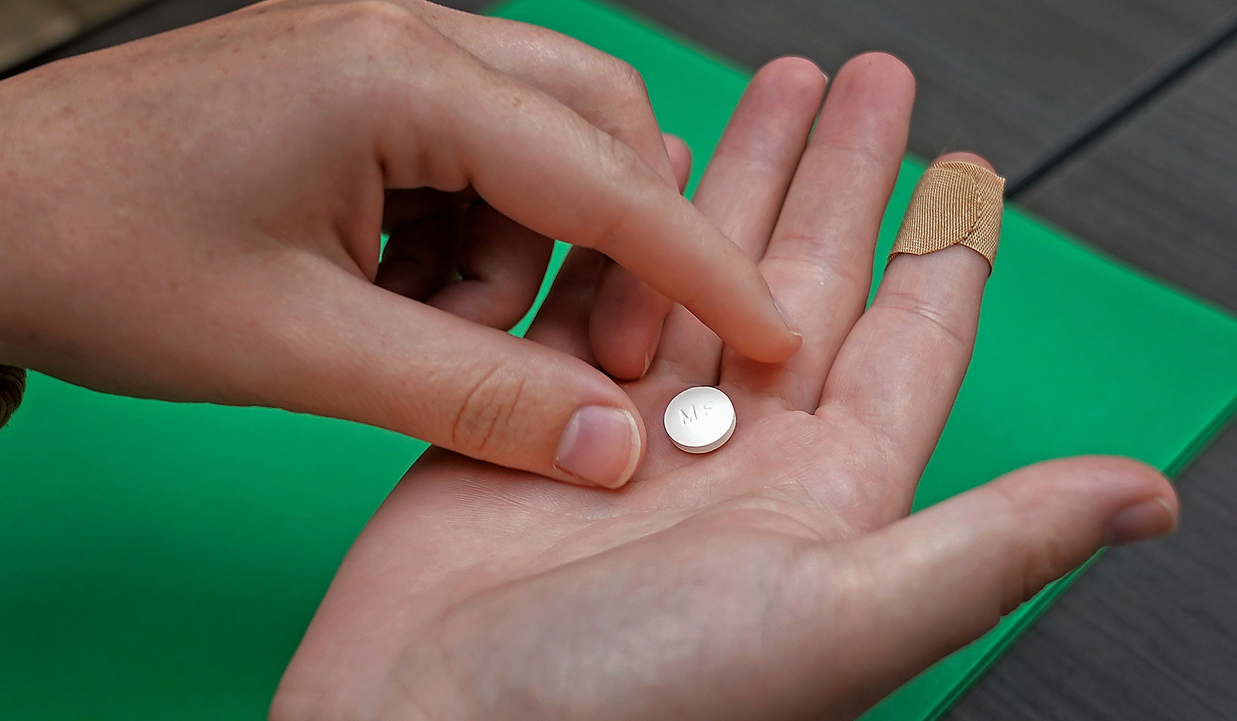 FILE - A patient prepares to take the first of two combination pills, mifepristone, for a medication abortion during a visit to a clinic in Kansas City, Kan., on, Oct. 12, 2022. More than six in 10 of the abortions in the United States last year were done through medication, up from 53% in 2020, according to research released Tuesday, March 19, 2024. The Guttmacher Institute, a research group that supports abortion rights, said about 642,700 medication abortions took place in the first full calendar year after the U.S. Supreme Court overturned Roe v. Wade. Medication abortion accounted for 63% of abortions in the formal health care system. (AP Photo/Charlie Riedel, File)