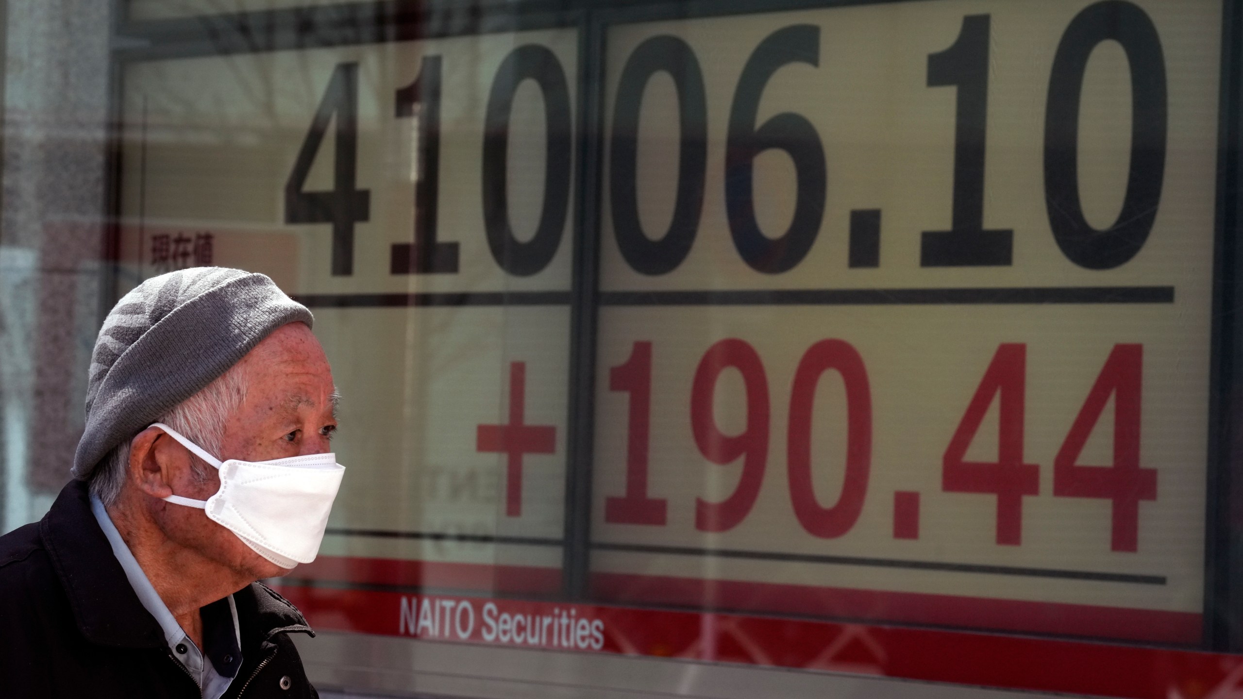 A person looks at an electronic stock board showing Japan's Nikkei 225 index at a securities firm Friday, March 22, 2024, in Tokyo. Stocks were mostly lower Friday in Asia after Wall Street tapped fresh records, led by big gains in chipmakers.(AP Photo/Eugene Hoshiko)