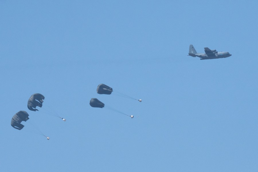 An aircraft airdrops humanitarian aid over northern Gaza Strip, as seen from southern Israel, Thursday, March 21, 2024. (AP Photo/Ohad Zwigenberg)