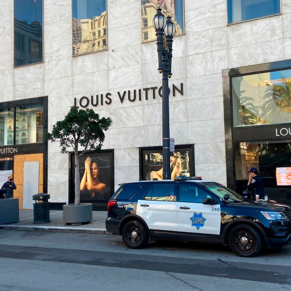 FILE - Police officers and emergency crews park outside the Louis Vuitton store in San Francisco's Union Square on Nov. 21, 2021, after looters ransacked businesses. Facing mounting pressure to crack down on a retail theft crisis, California lawmakers are split on how best to tackle the problem that some say had caused major store closures and products like deodorants to be locked behind plexiglass. (Danielle Echeverria/San Francisco Chronicle via AP, File)