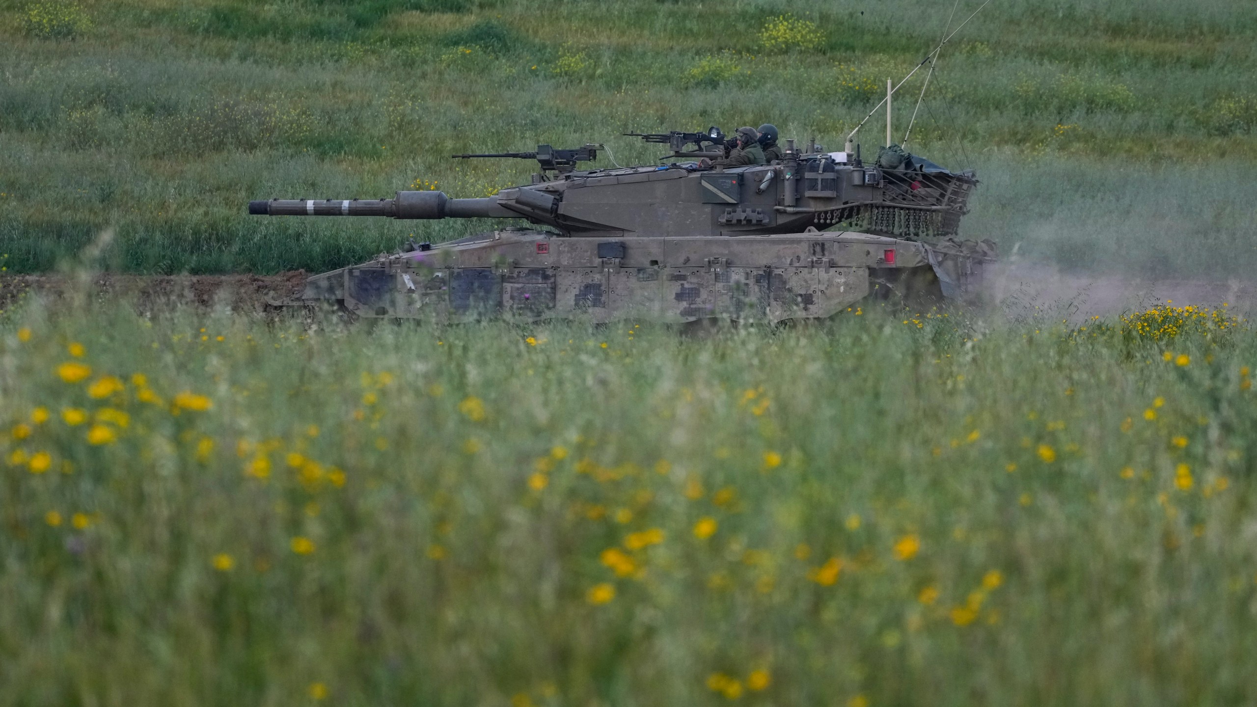 Israeli soldiers drive a tank in southern Israel, near the border with the Gaza Strip, Sunday, March 24, 2024. (AP Photo/Tsafrir Abayov)