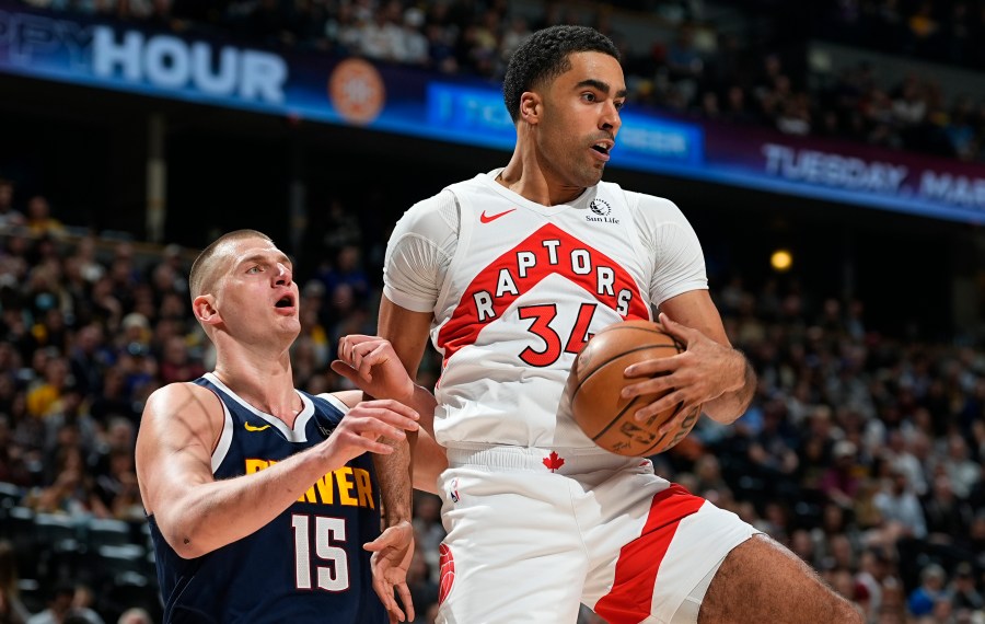 Toronto Raptors center Jontay Porter, right, pulls in a rebound as Denver Nuggets center Nikola Jokic, left, defends in the first half of an NBA basketball game Monday, March 11, 2024, in Denver. (AP Photo/David Zalubowski)