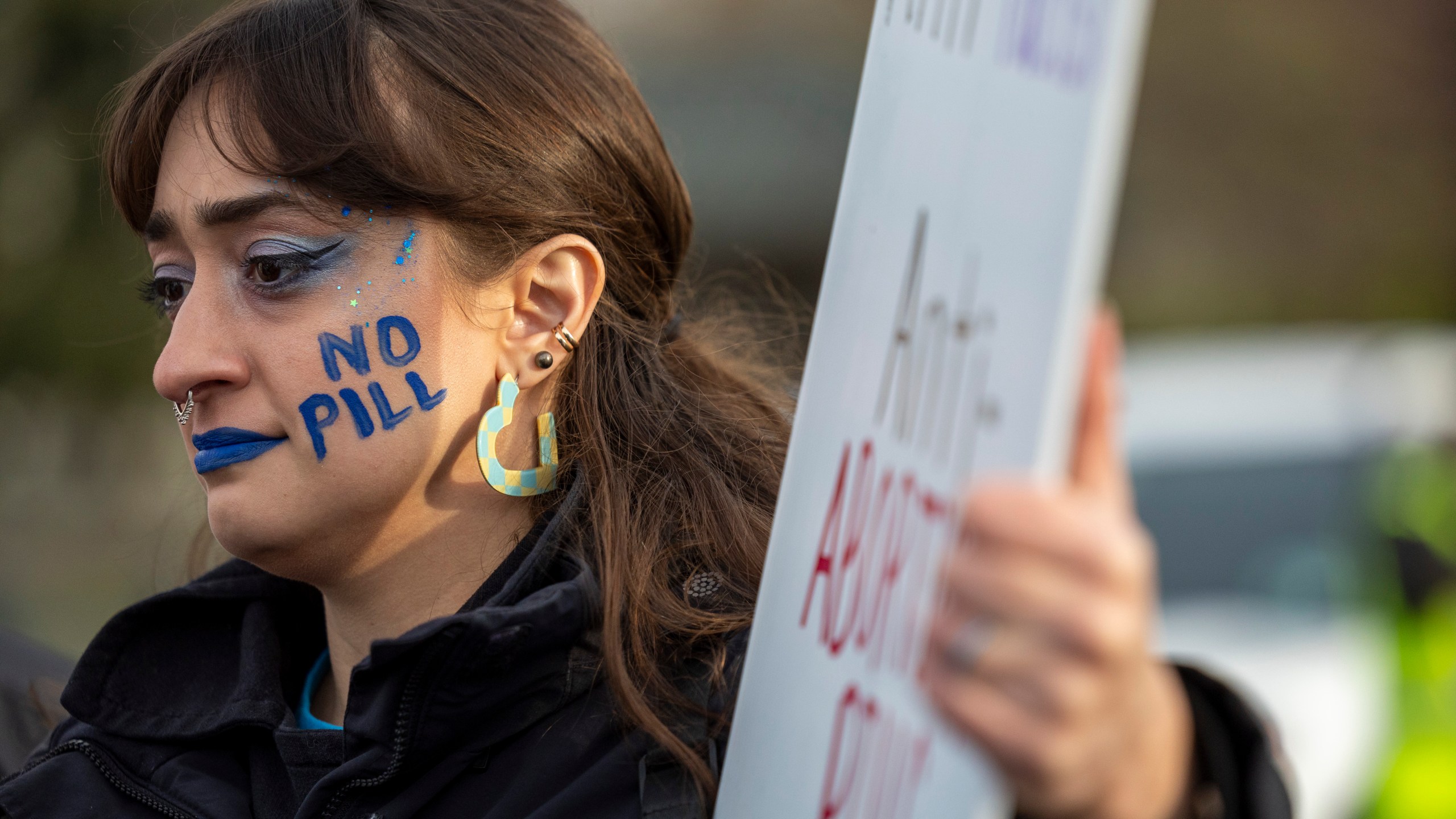 Anti-abortion activist Elise Ketch wears face paint outside the Supreme Court, Tuesday, March 26, 2024, in Washington. The Supreme Court is hearing arguments in its first abortion case since conservative justices overturned the constitutional right to an abortion two years ago. At stake in Tuesday's arguments is the ease of access to a medication used last year in nearly two-thirds of U.S. abortions. (AP Photo/Amanda Andrade-Rhoades)