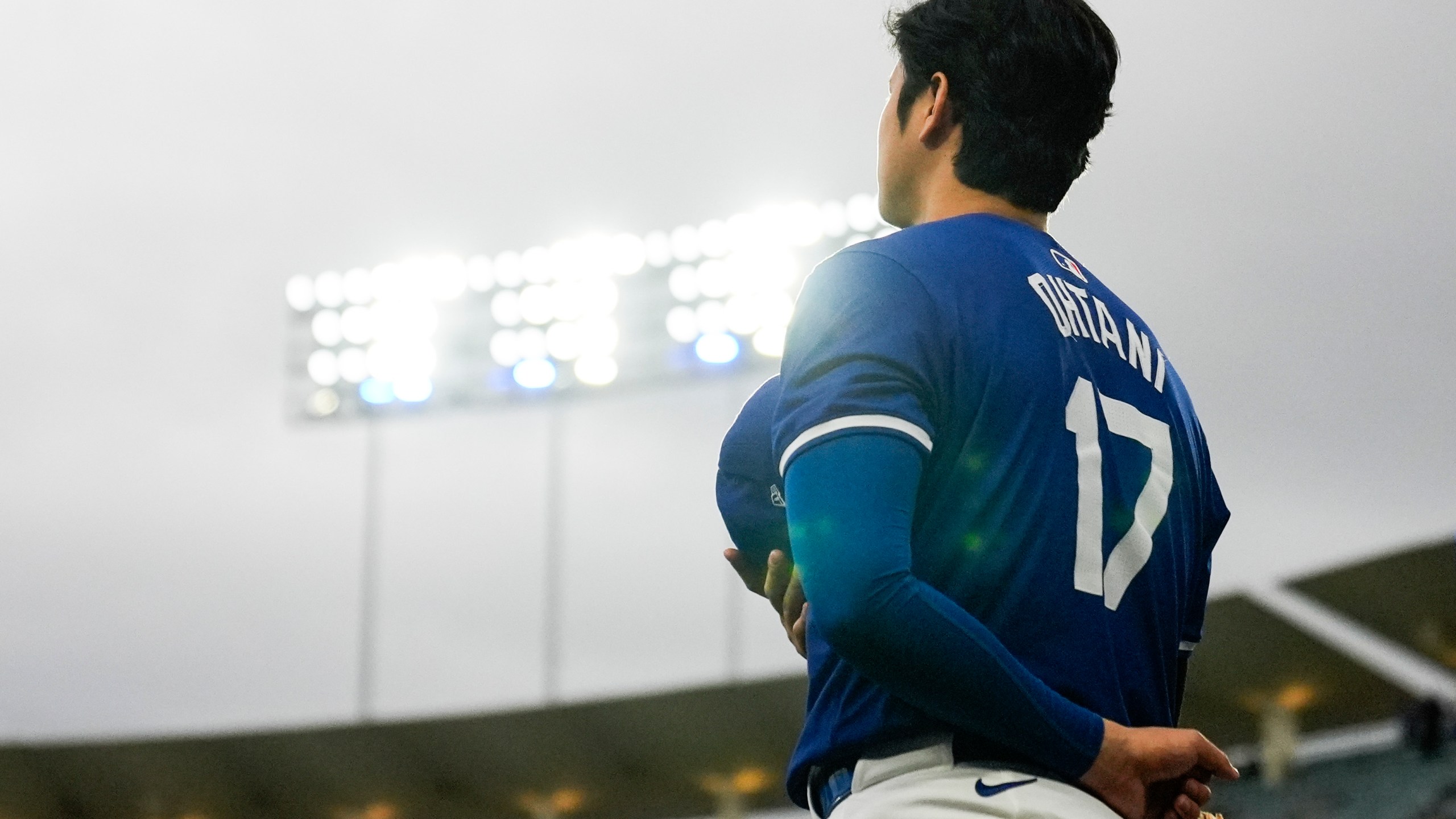 Los Angeles Dodgers designated hitter Shohei Ohtani (17) stands as the national anthem plays before a spring training baseball game against the Los Angeles Angels in Los Angeles, Sunday, March 24, 2024. (AP Photo/Ashley Landis)